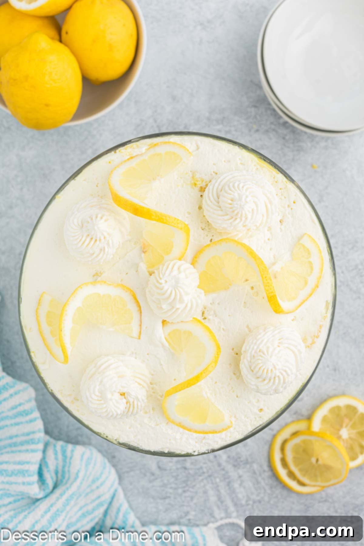 A close-up of a lemon trifle, garnished with elegant lemon slices, highlighting the creamy texture and vibrant color.