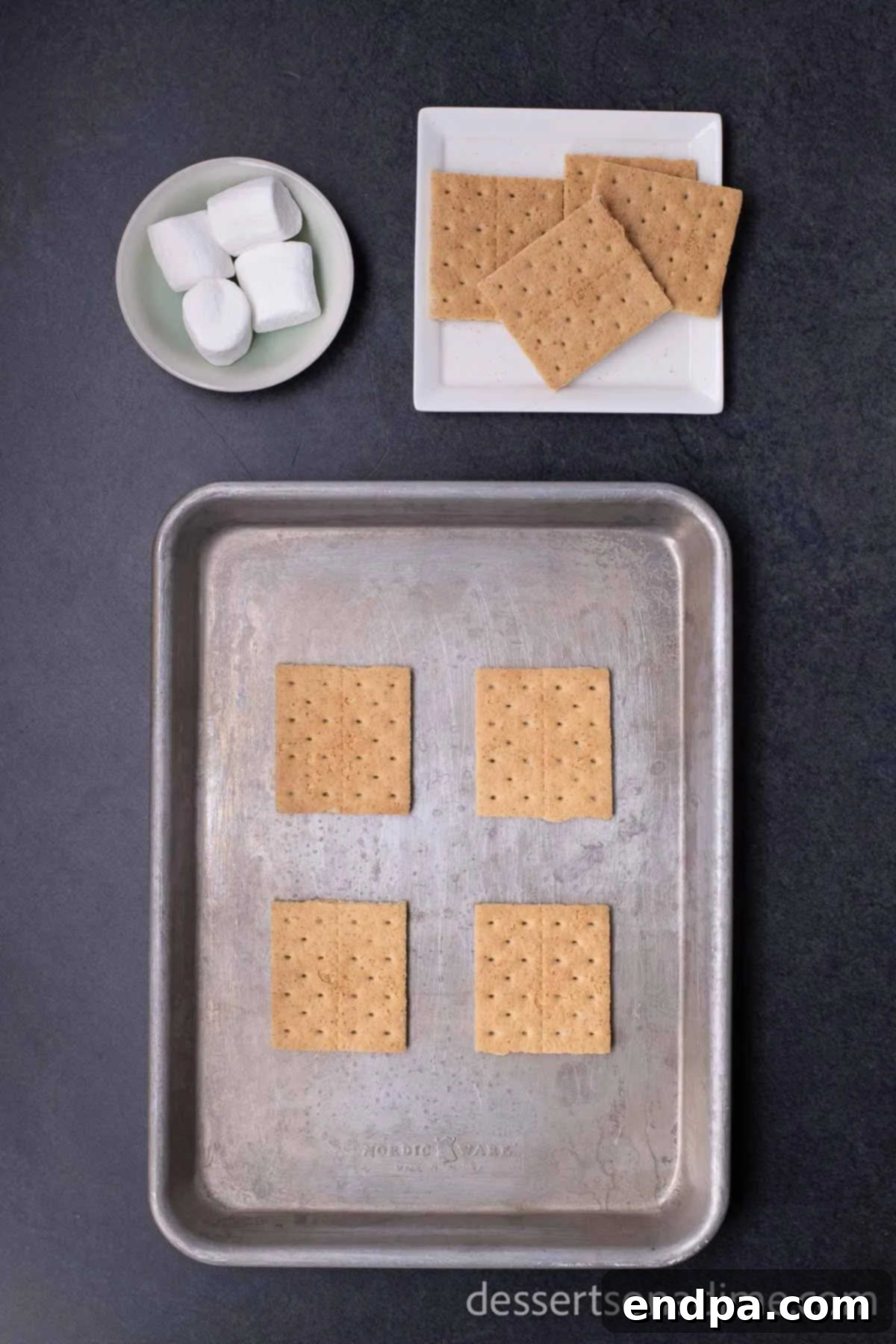 Perfect Oven S'mores: Your Campfire-Free Indulgence 2 Placing graham cracker halves on a baking sheet, ready for marshmallows