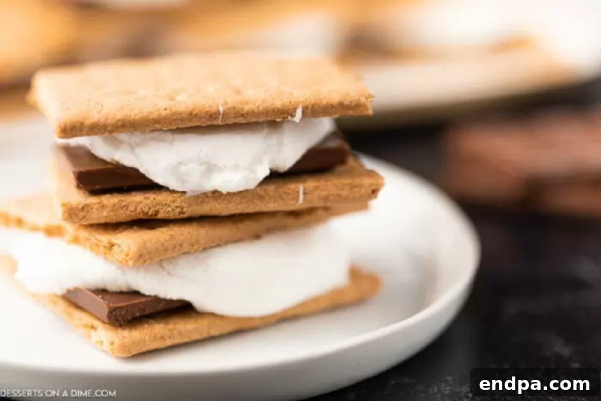 Oven baked smores are so convenient and you still can enjoy all the ooey gooey marshmallows and decadent chocolate. Try oven smores. Three oven s'mores stacked on a plate, ready to be enjoyed