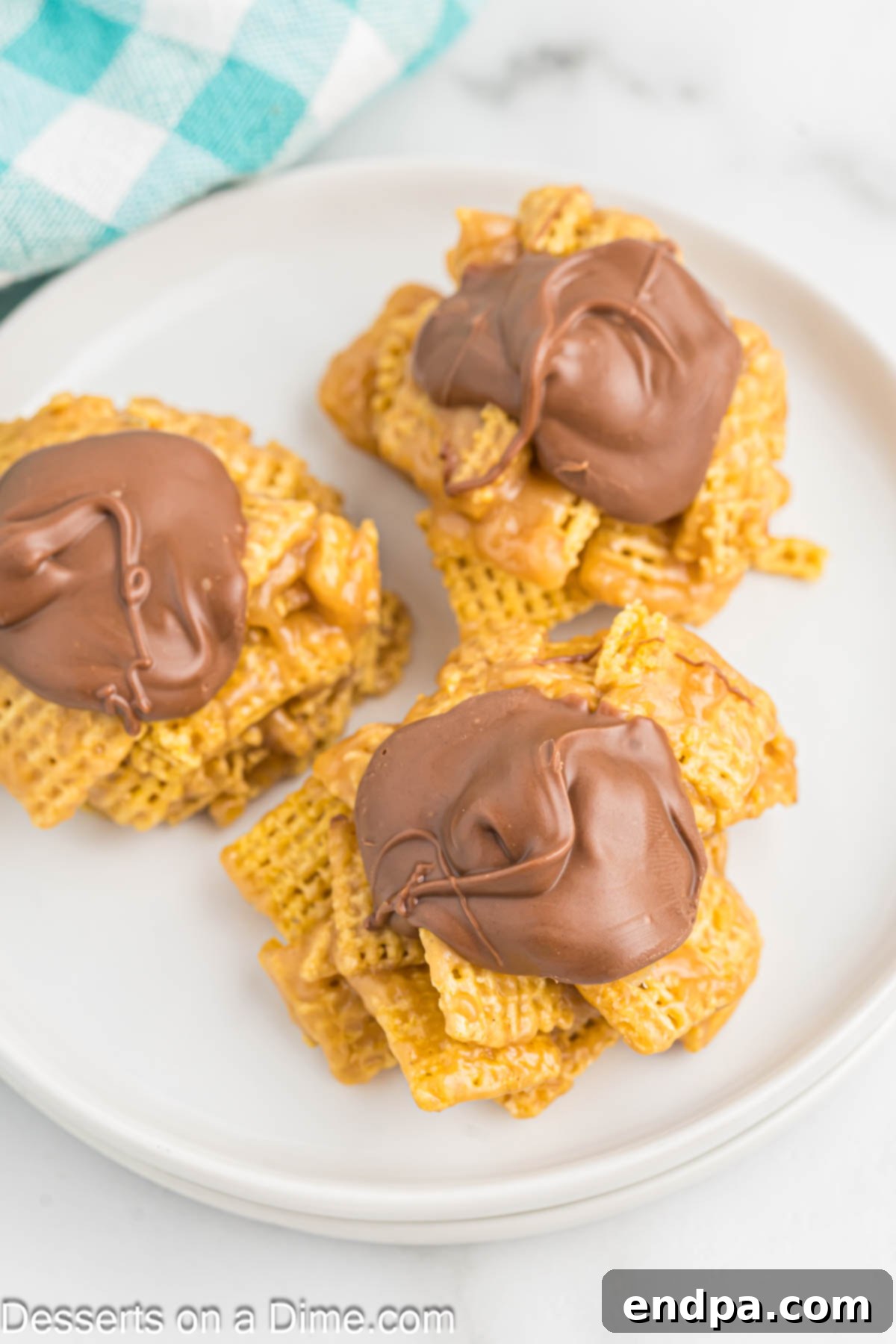 Chex Peanut Butterscotch Crunch 10 A close-up of Chex Scotcheroos on a plate, showcasing their delightful texture and chocolate topping.