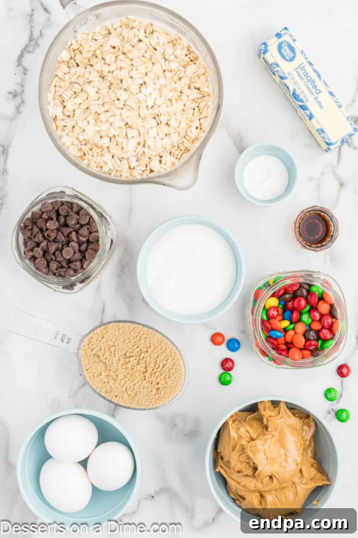 Ingredients for Monster Cookies - softened butter, creamy peanut butter, brown sugar, granulated sugar, eggs, vanilla extract, baking soda, old-fashioned oats, semi-sweet chocolate chips, and M&M's.