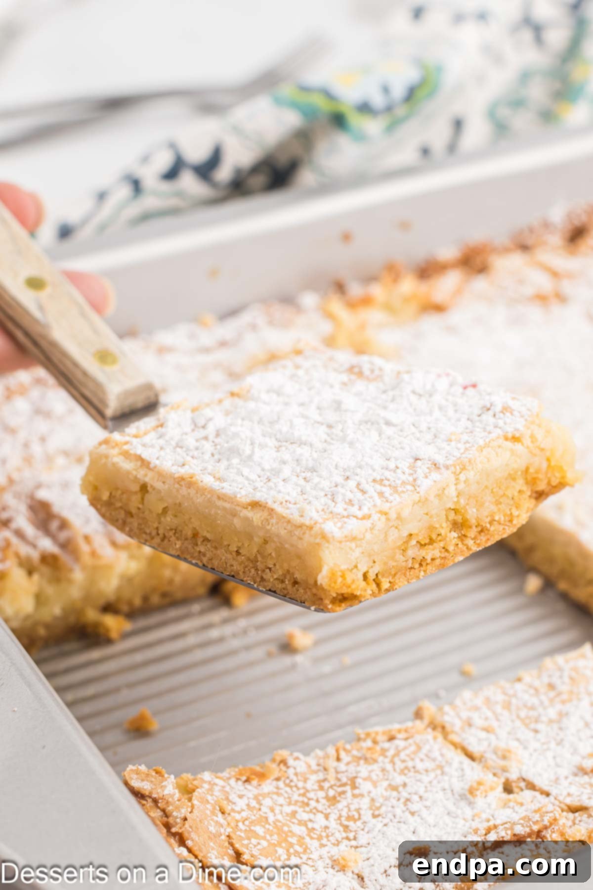The Ooey Gooey Butter Cake perfectly cut into even squares, ready for serving.