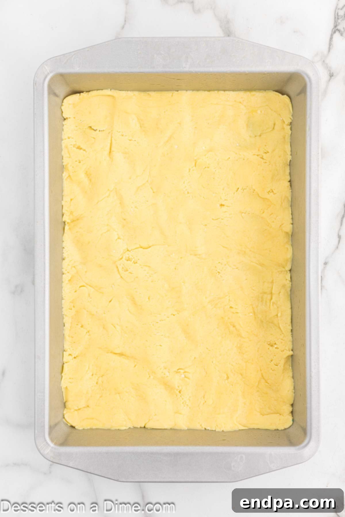 The cake crust mixture evenly spread into the bottom of a 9x13 inch baking dish.