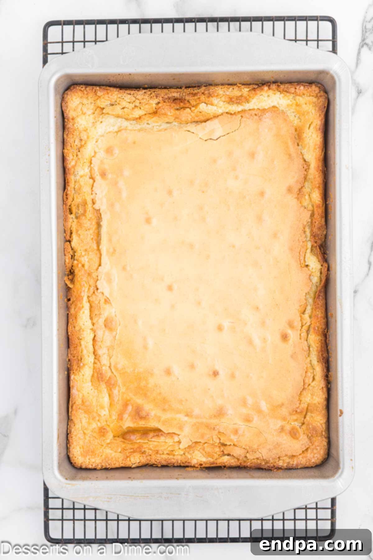 The Ooey Gooey Butter Cake after baking, golden brown around the edges with a slightly gooey center.