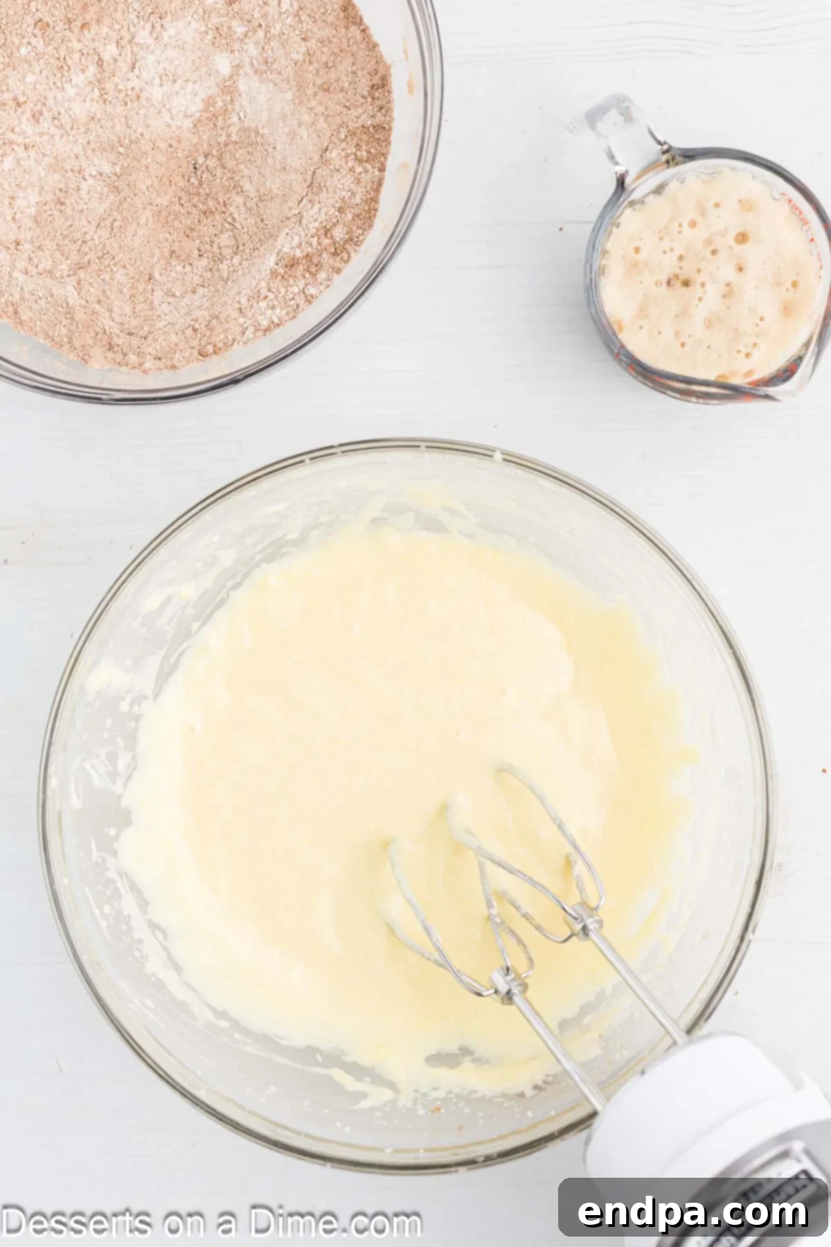 Large mixing bowl with creamed butter and sugar, then eggs and vanilla added.