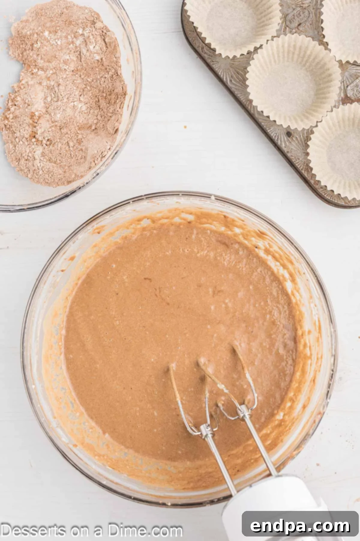 Wet and dry ingredients partially combined in a mixing bowl with Guinness beer.