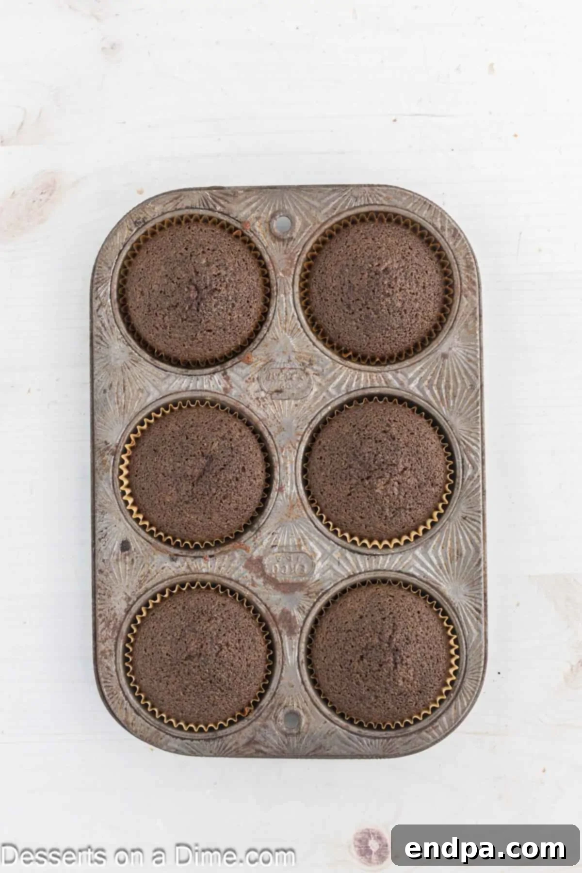 Baked cupcakes cooling in the muffin pan.