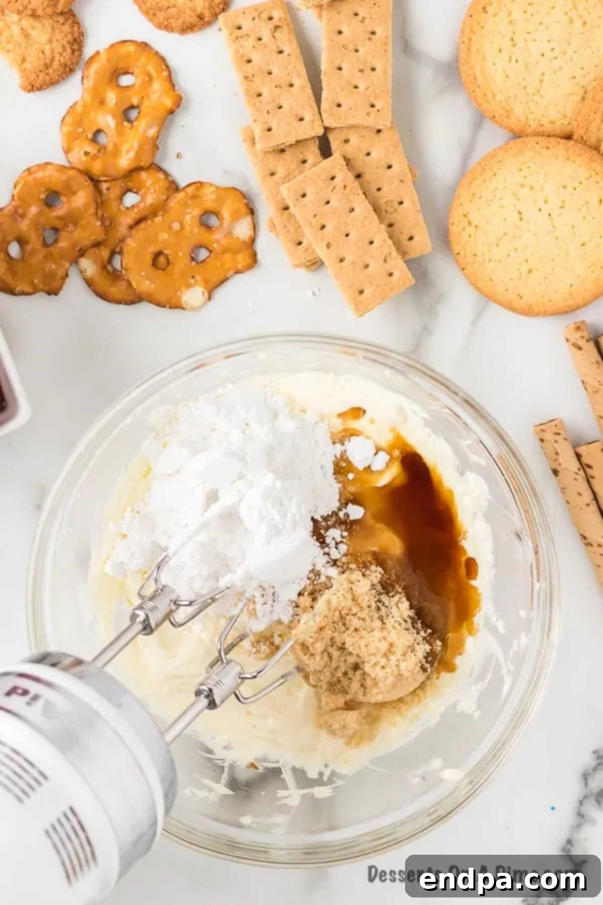 Heavenly Cheesecake Dip 5 Mixing bowl with powdered sugar, brown sugar, and vanilla extract added to the cream cheese and butter mixture.