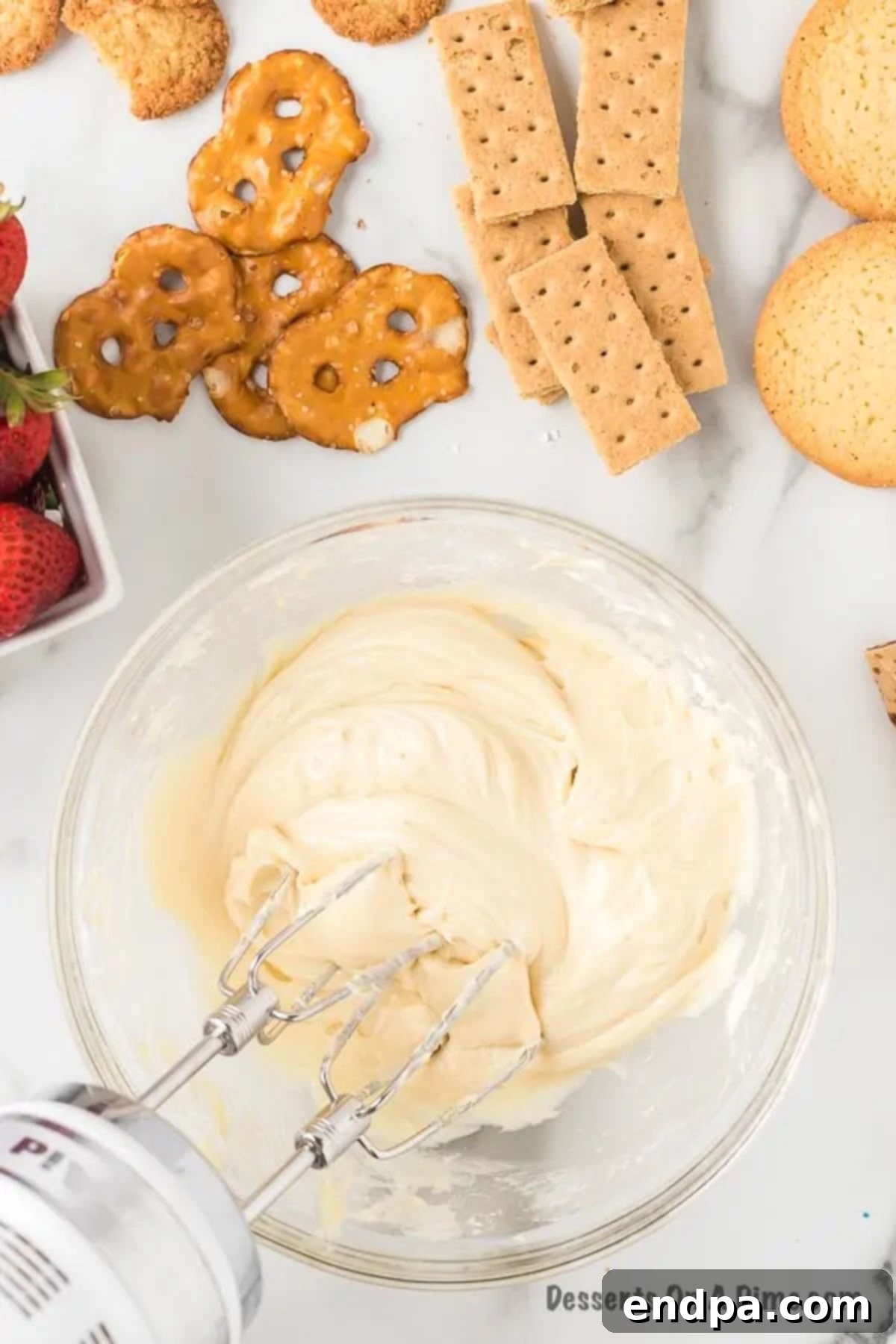 Heavenly Cheesecake Dip 6 The fully combined cheesecake dip mixture in a mixing bowl, smooth and ready to be transferred.