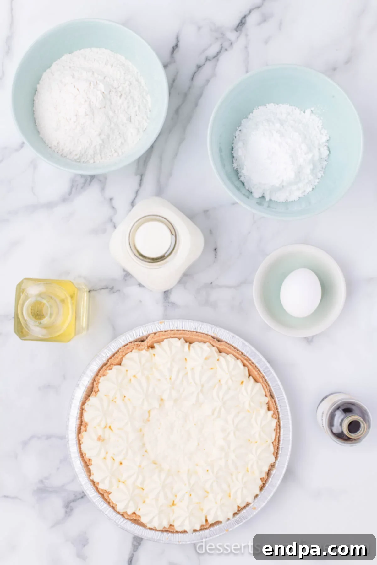 Crispy Cheesecake Indulgence 3 All the essential ingredients for Deep Fried Cheesecake laid out: frozen cheesecake, pancake mix, egg, milk, vegetable oil, and powdered sugar.
