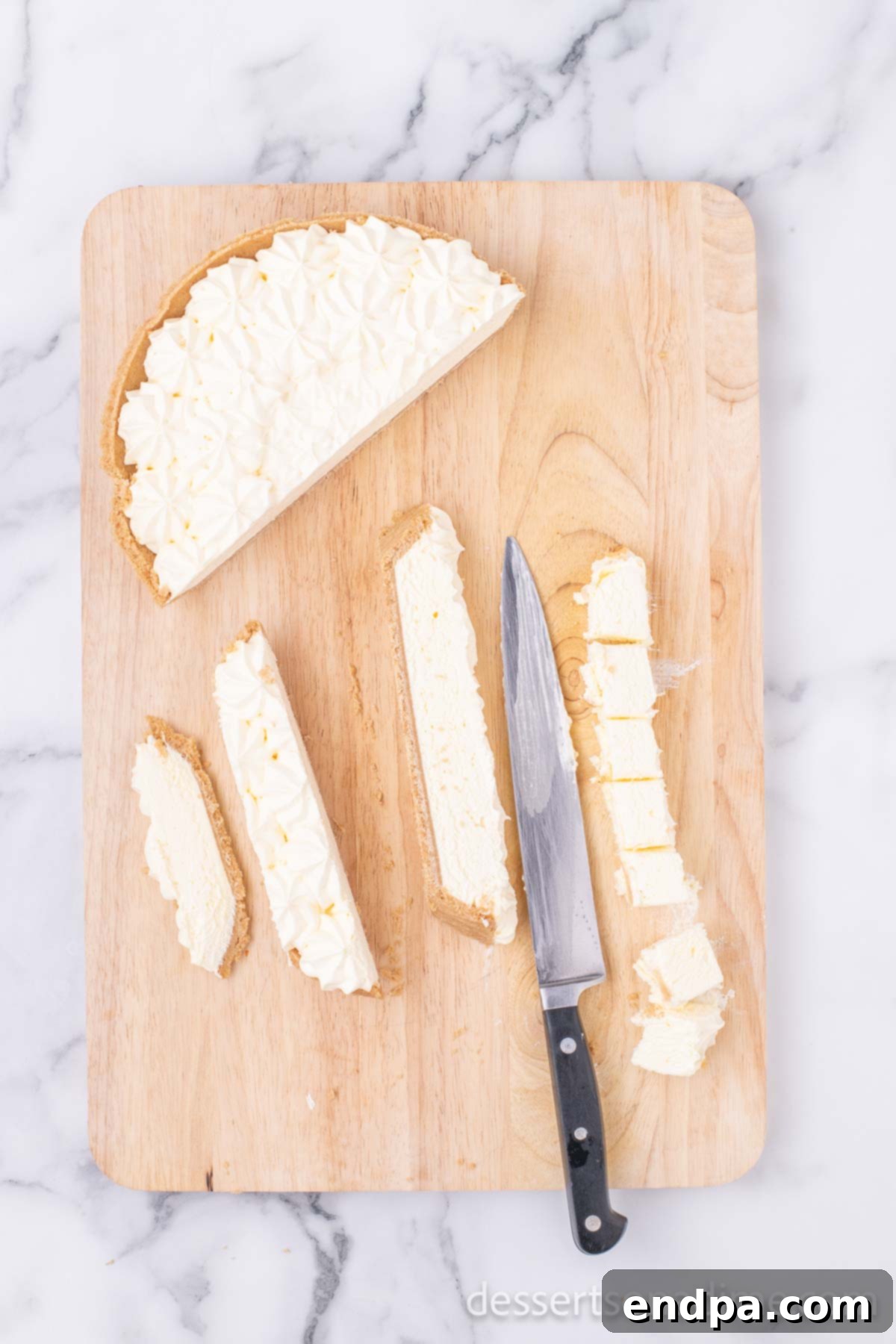 Crispy Cheesecake Indulgence 4 Frozen cheesecake being carefully cut into small, even pieces before frying.