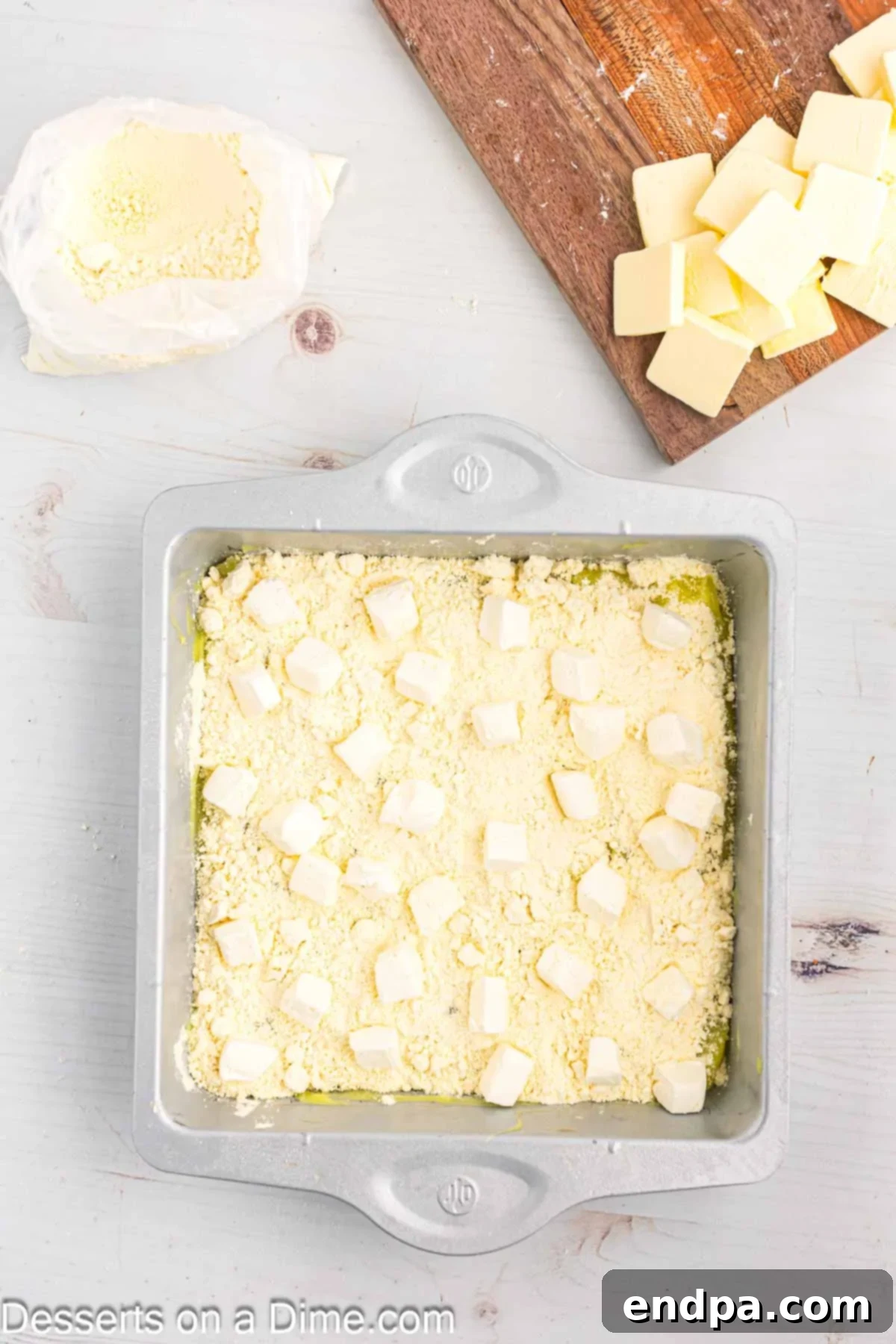 Zesty Lemon Easy Bake 7 Small, evenly diced pieces of cream cheese scattered over the layer of dry cake mix and lemon filling.