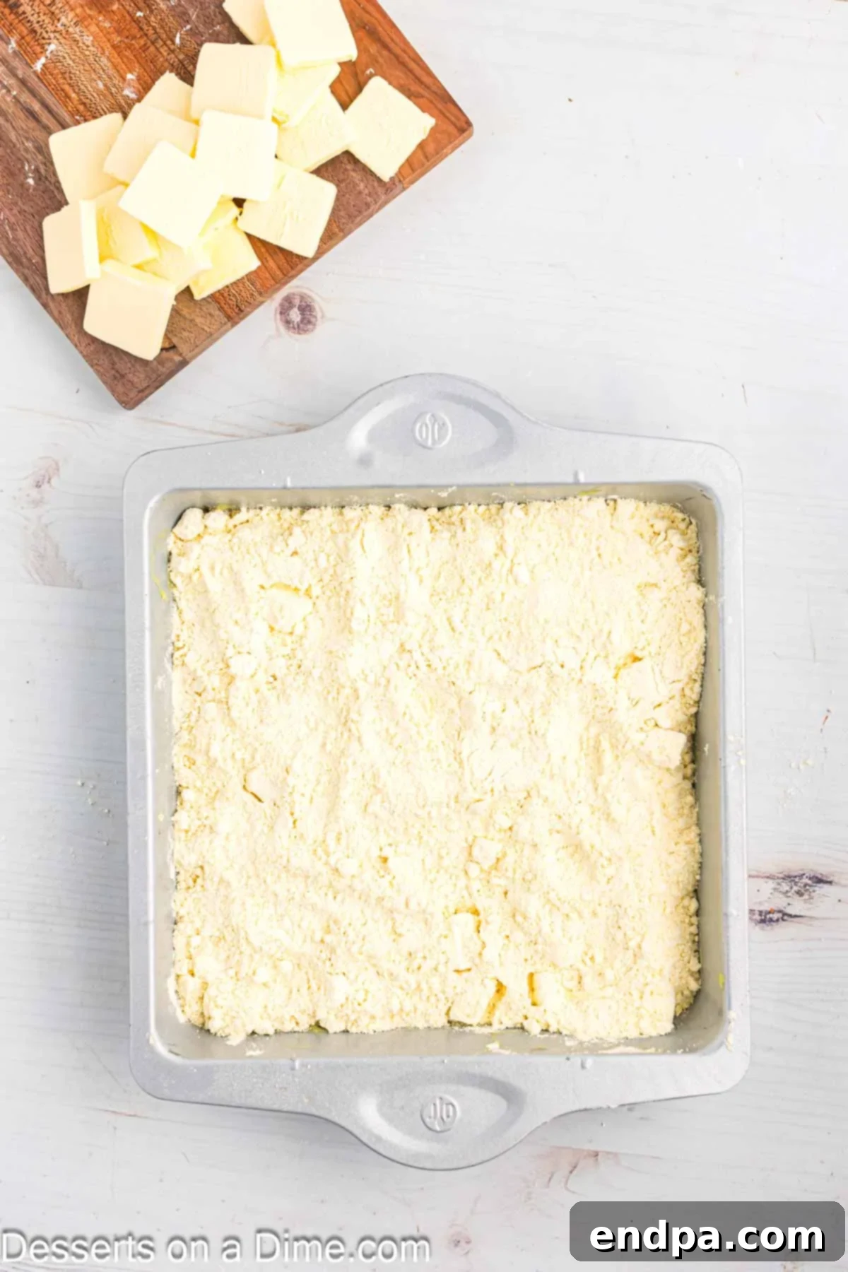 Zesty Lemon Easy Bake 8 The remaining dry yellow cake mix is generously sprinkled over the cream cheese pieces, completely covering the layer.