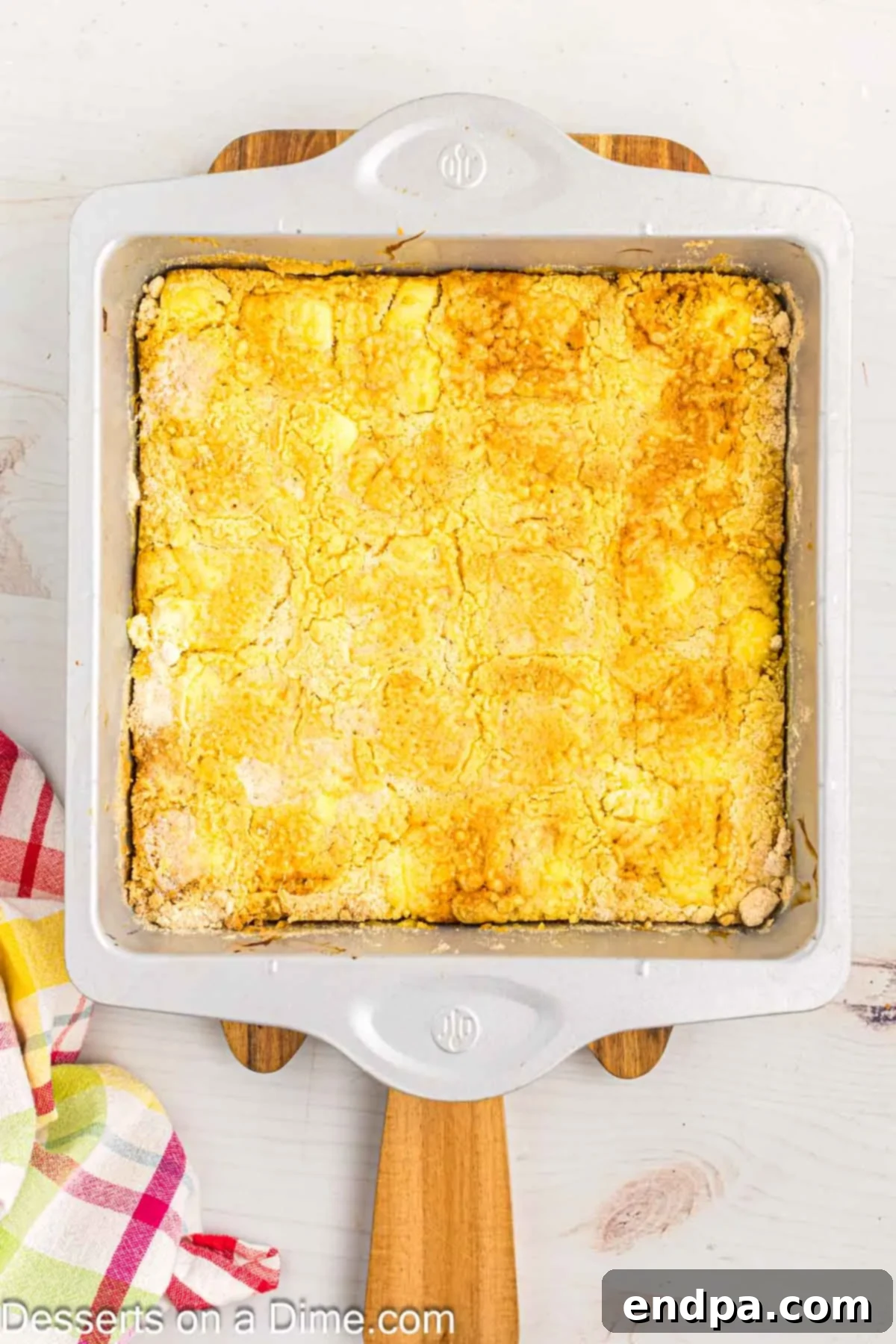 Zesty Lemon Easy Bake 10 The baked lemon dump cake in the white baking dish, golden brown and bubbling around the edges, just out of the oven.