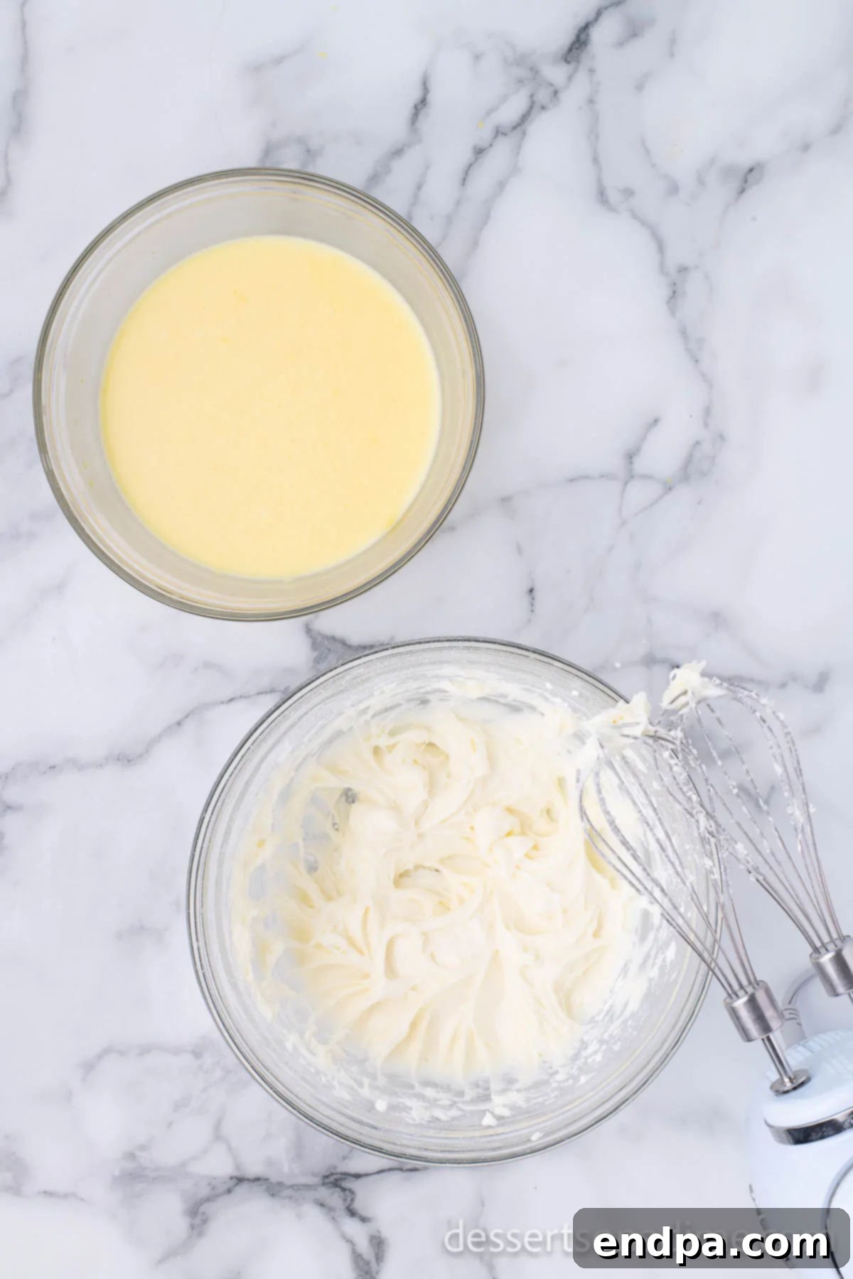 A bowl containing a light, fluffy cream cheese mixture, blended and smooth.