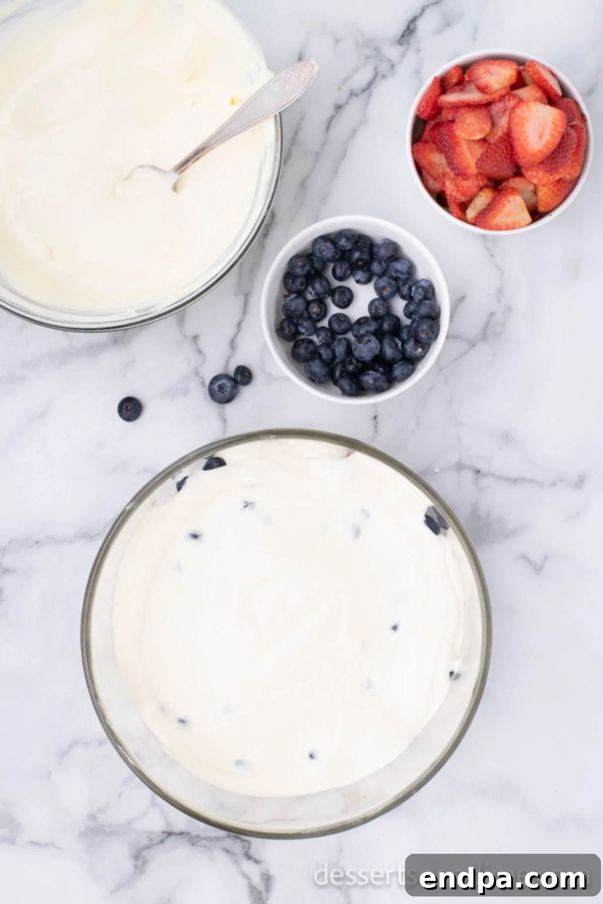 A smooth, white layer of pudding mixture spread over the cake base in a trifle dish.