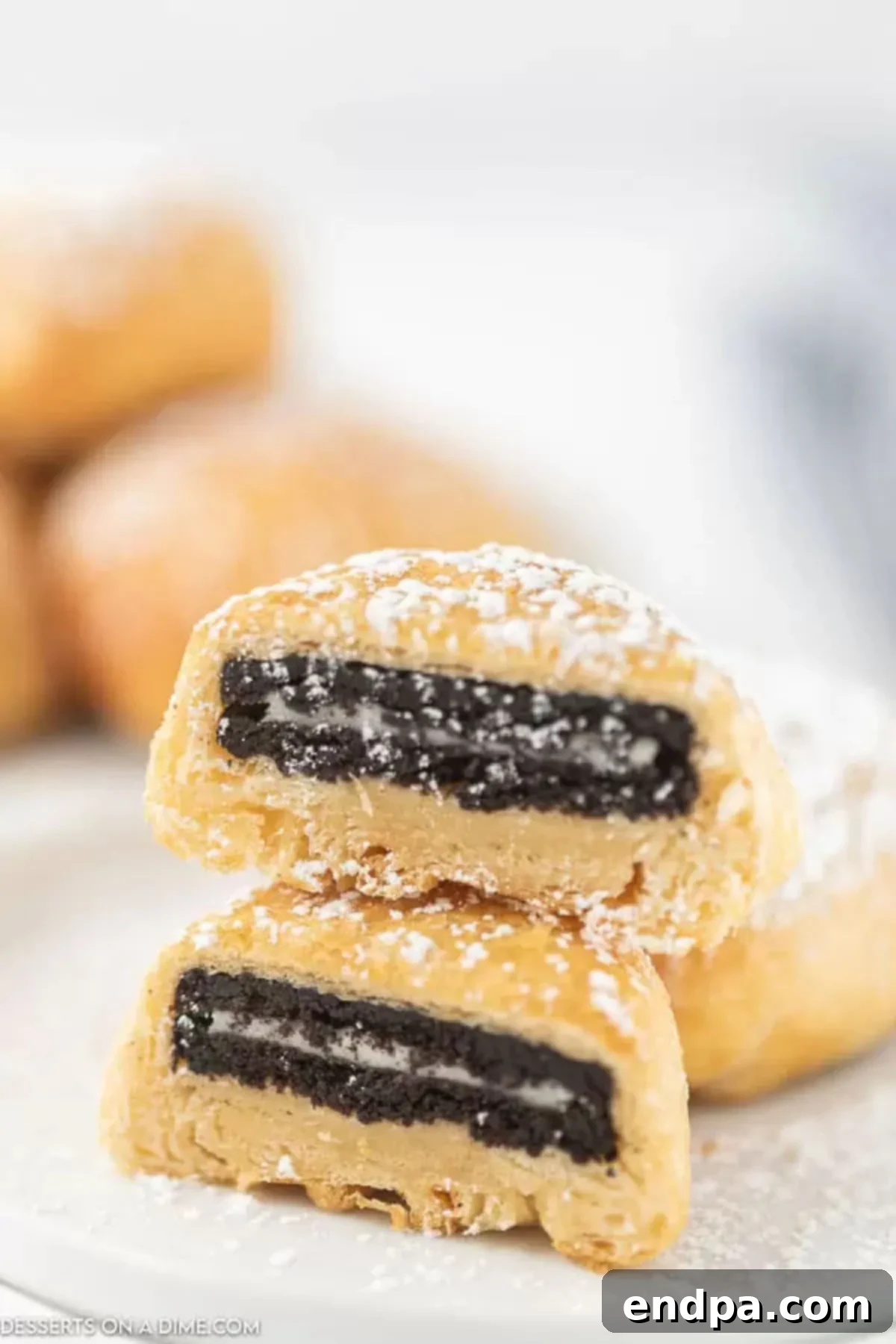 Air Fryer Oreo Magic 5 Air fryer Oreo cookies topped with powdered sugar.