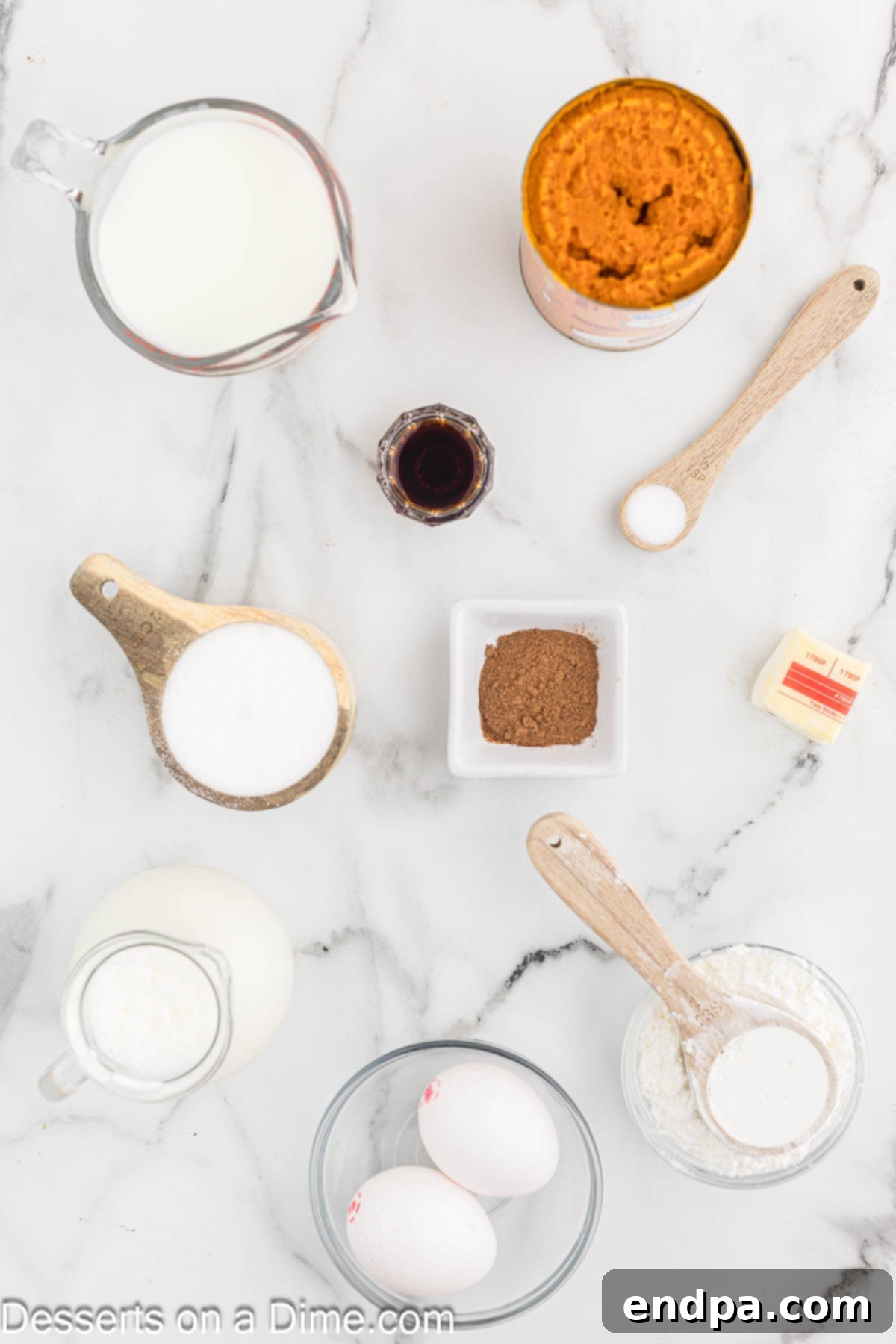 Spiced Pumpkin Dream 3 Ingredients for Pumpkin Pudding laid out on a table: milk, heavy cream, pumpkin puree, cornstarch, eggs, butter, vanilla extract, and pumpkin pie spice.