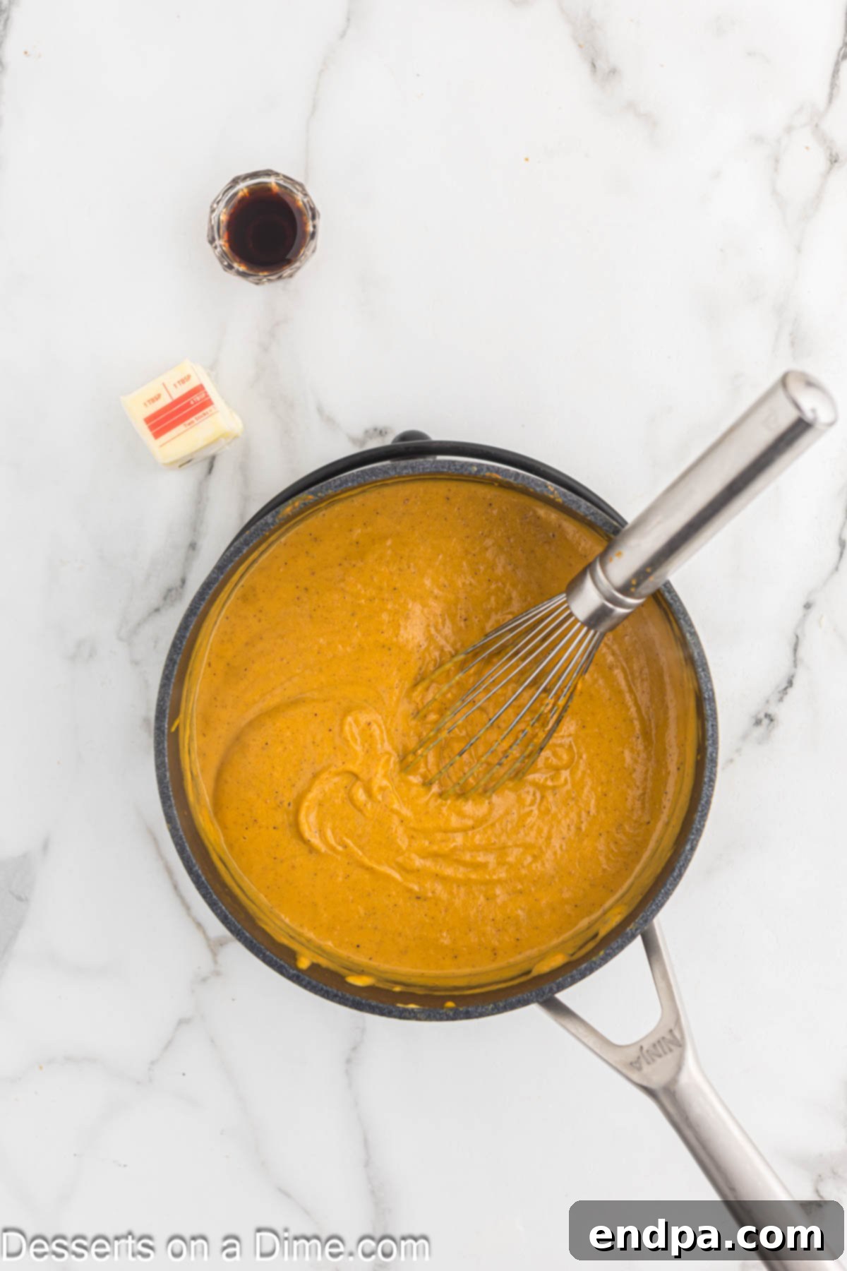 Spiced Pumpkin Dream 4 Pumpkin puree, milk, heavy cream, and pumpkin pie spice combined in a saucepan on the stove.