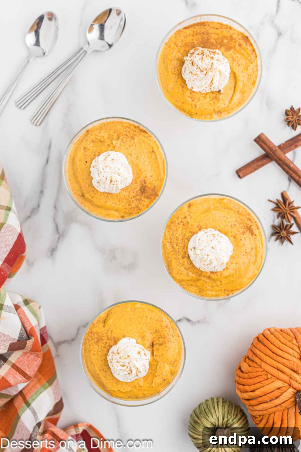 Spiced Pumpkin Dream 10 Individual servings of pumpkin pudding in glass dishes, garnished with whipped cream and a sprinkle of spice.