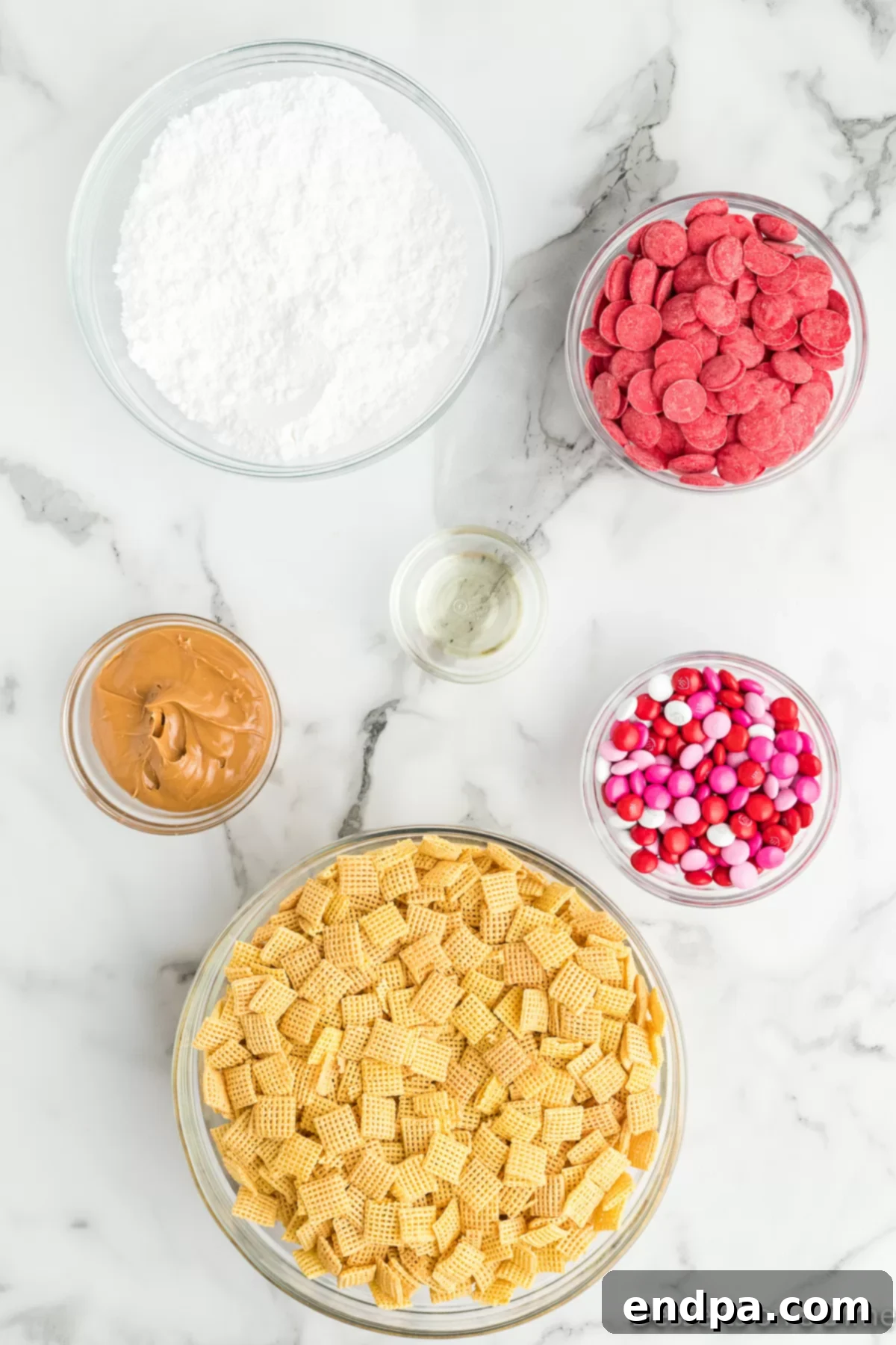 Ingredients needed: Chex cereal, creamy peanut butter, vegetable oil, red candy melts, powdered sugar, and Valentine's M&Ms.