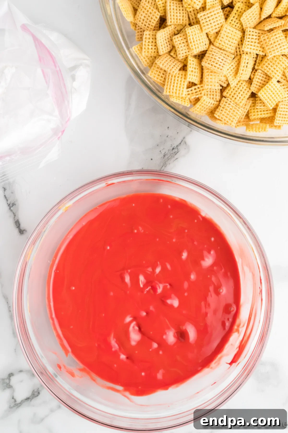 Red candy coating melted smoothly in a microwave-safe bowl.