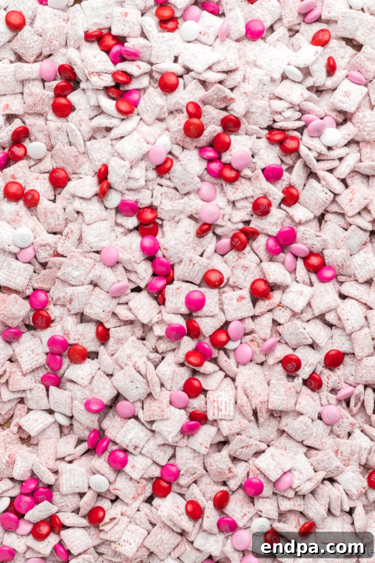 Valentine Puppy Chow served in a decorative bowl, ready to be enjoyed.