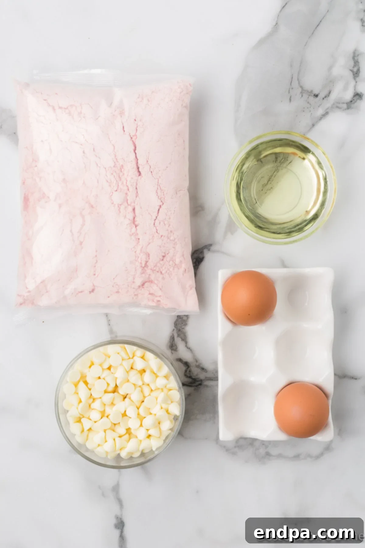 Ingredients for recipe - cake mix, eggs, oil, white chocolate chips. 