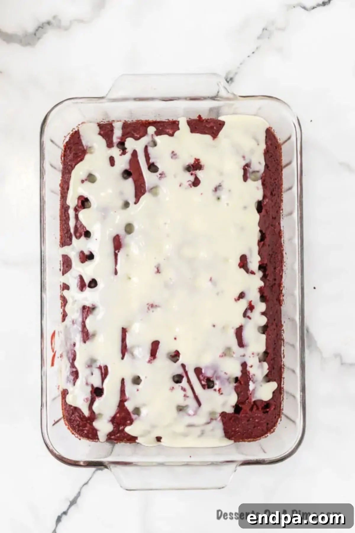 Red Velvet Infusion Cake 7 Sweetened Condensed Milk being poured over the poked Red Velvet Cake.