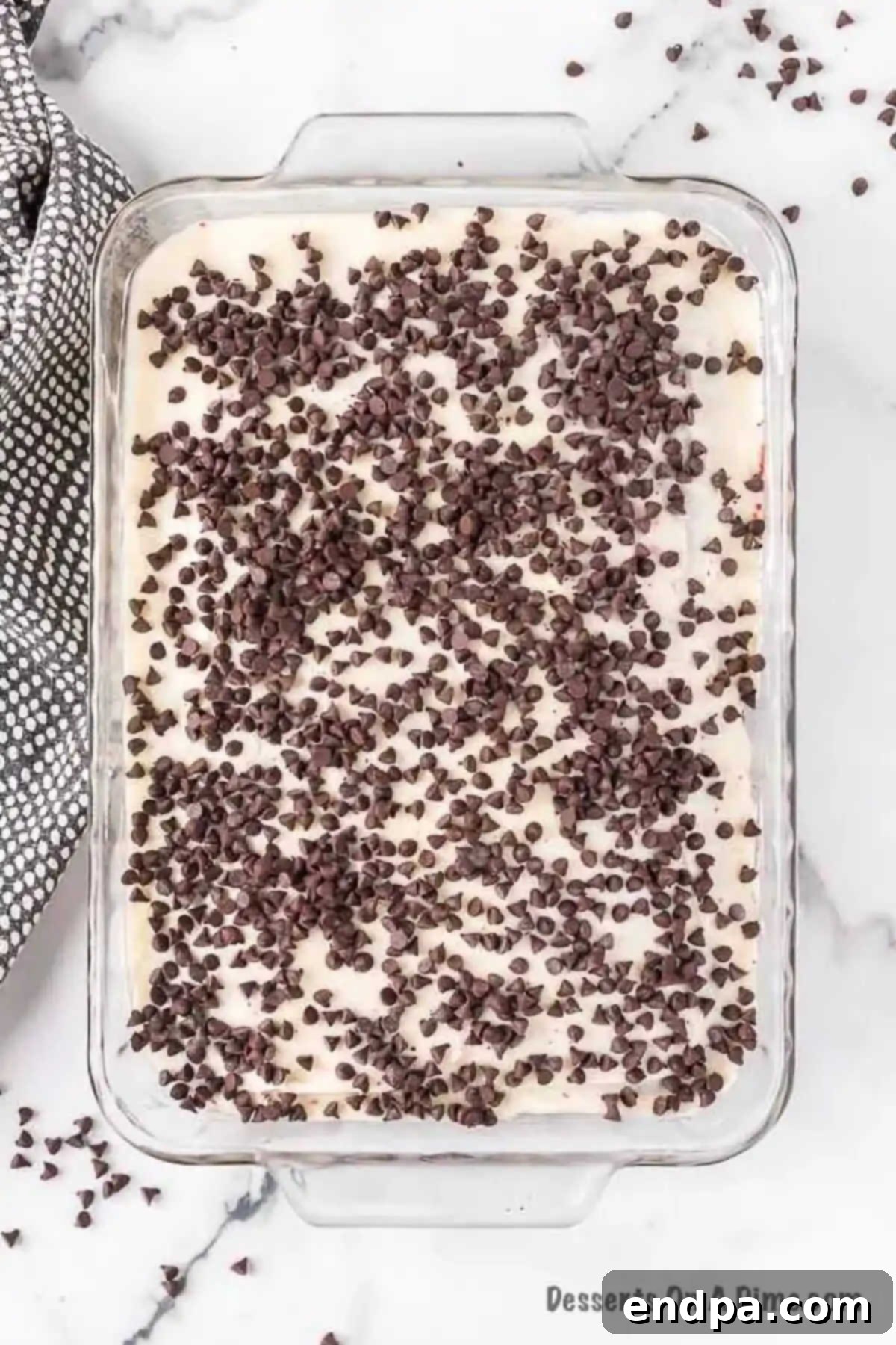 Red Velvet Infusion Cake 9 Mini chocolate chips sprinkled generously over the frosted Red Velvet Poke Cake.