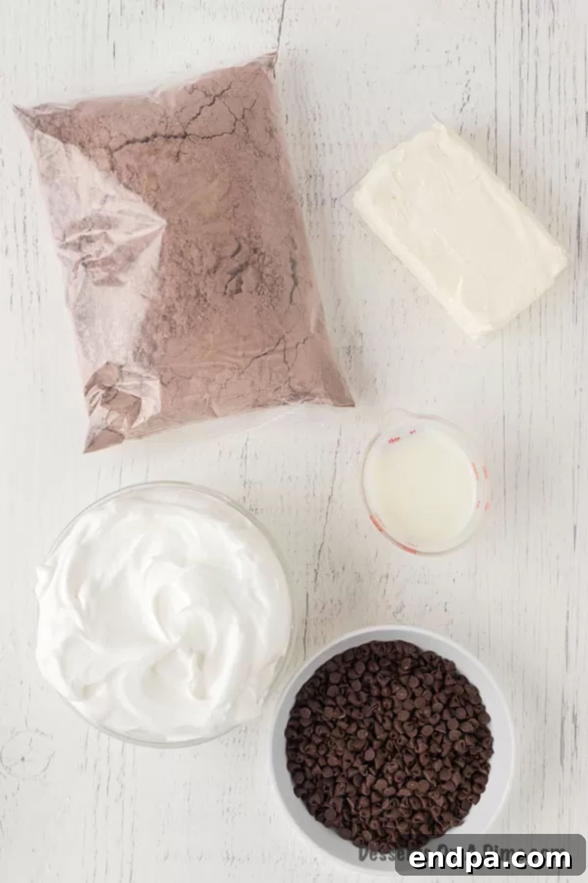 Decadent Brownie Dip 3 Key ingredients for brownie dip: cream cheese, whipped topping, brownie mix, milk, and mini chocolate chips.