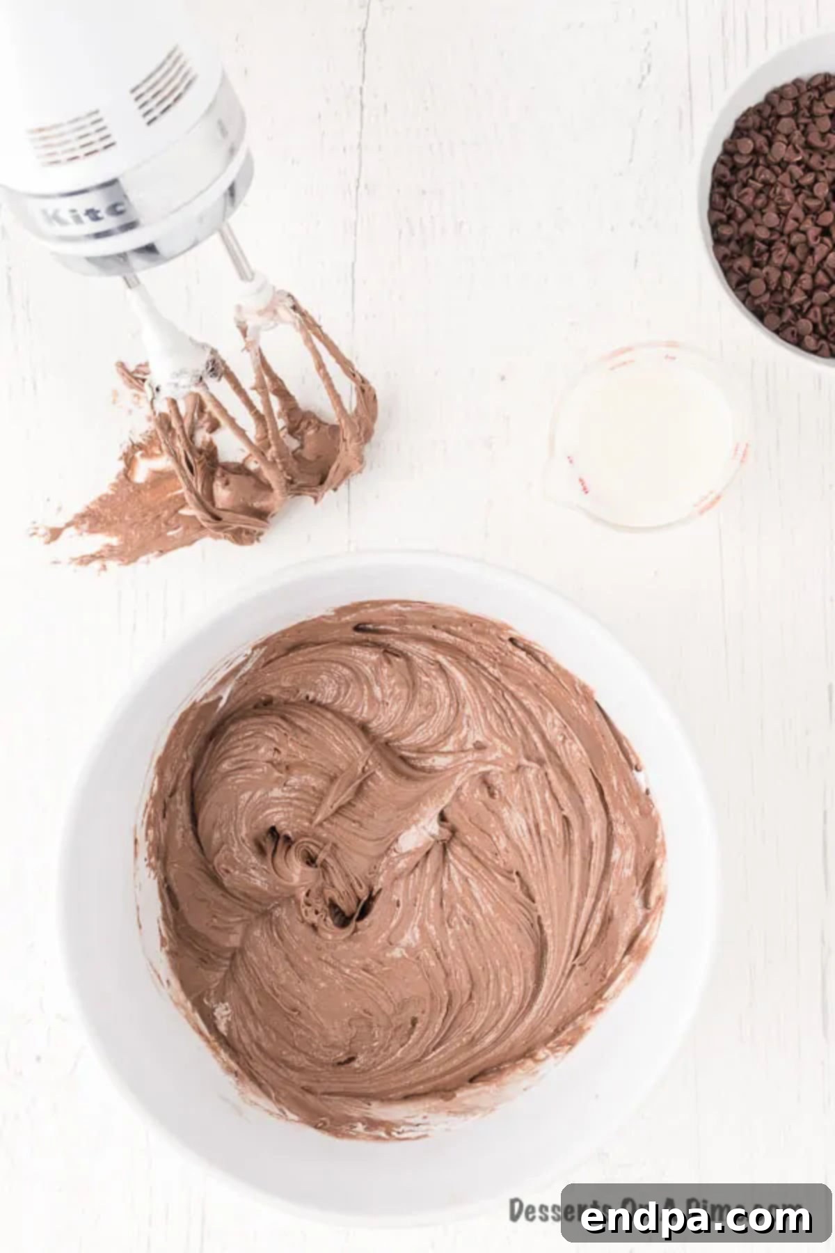 Decadent Brownie Dip 6 Thawed whipped topping being gently folded into the brownie and cream cheese mixture.