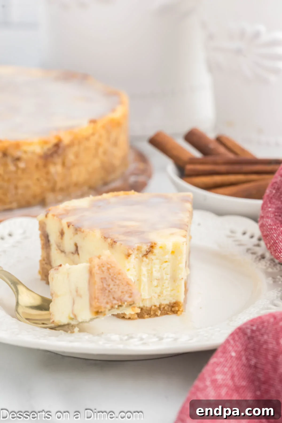 Golden Honey Swirl Cheesecake 12 Honey Bun Cheesecake sliced and served on a plate.