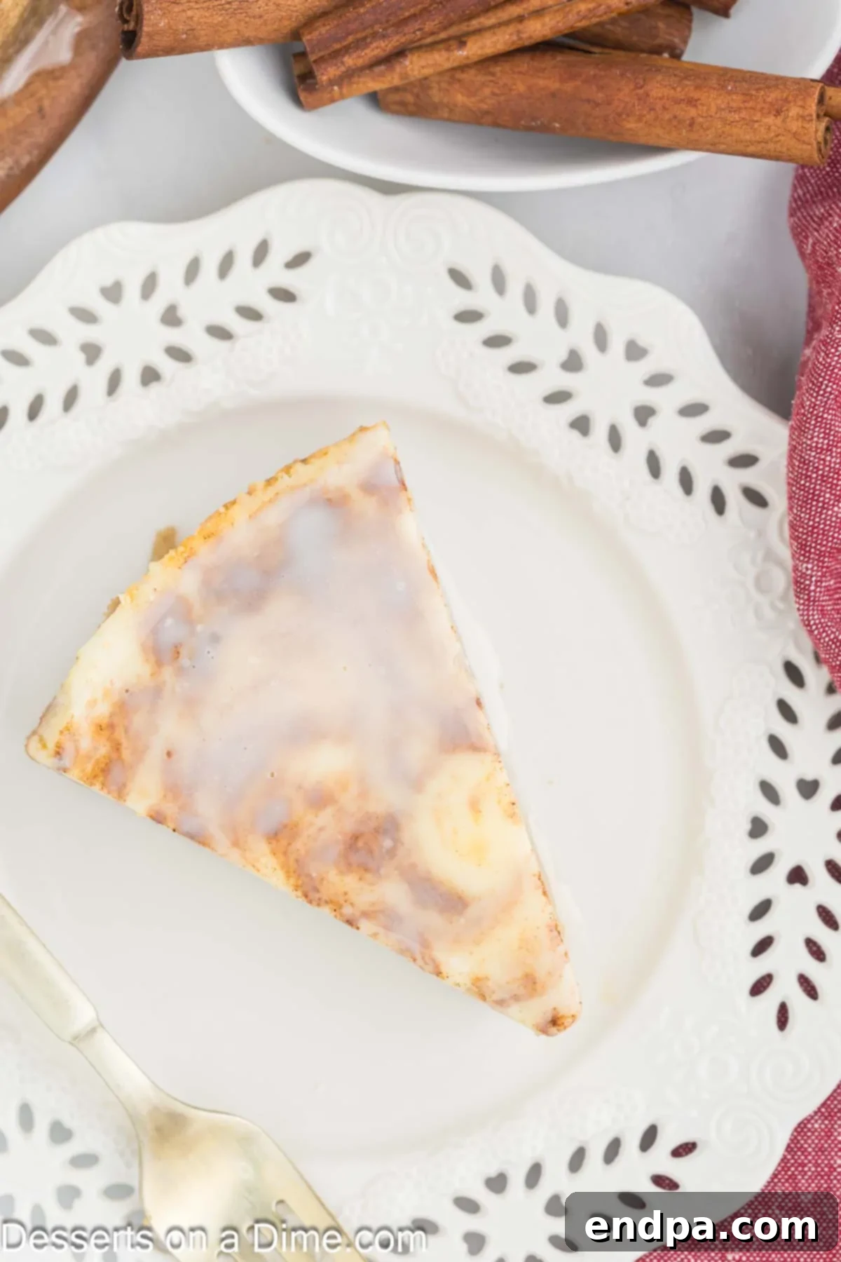 Golden Honey Swirl Cheesecake 13 Cheesecake sliced and served on a plate with glaze on top.