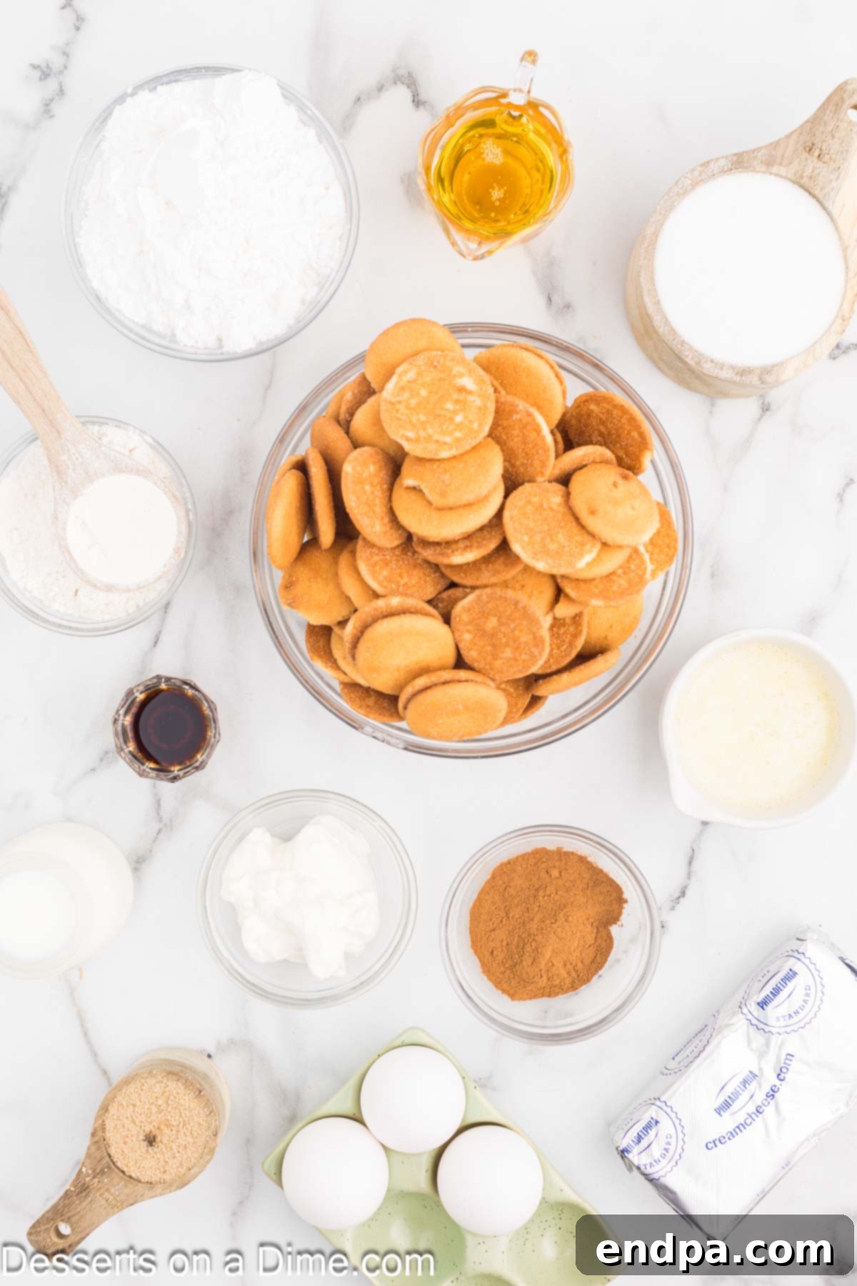 Golden Honey Swirl Cheesecake 3 Ingredients for Honey Bun Cheesecake - vanilla wafers, butter, ground cinnamon, cream cheese, eggs, sour cream, honey, vanilla extract, flour, brown sugar, powdered sugar, milk.