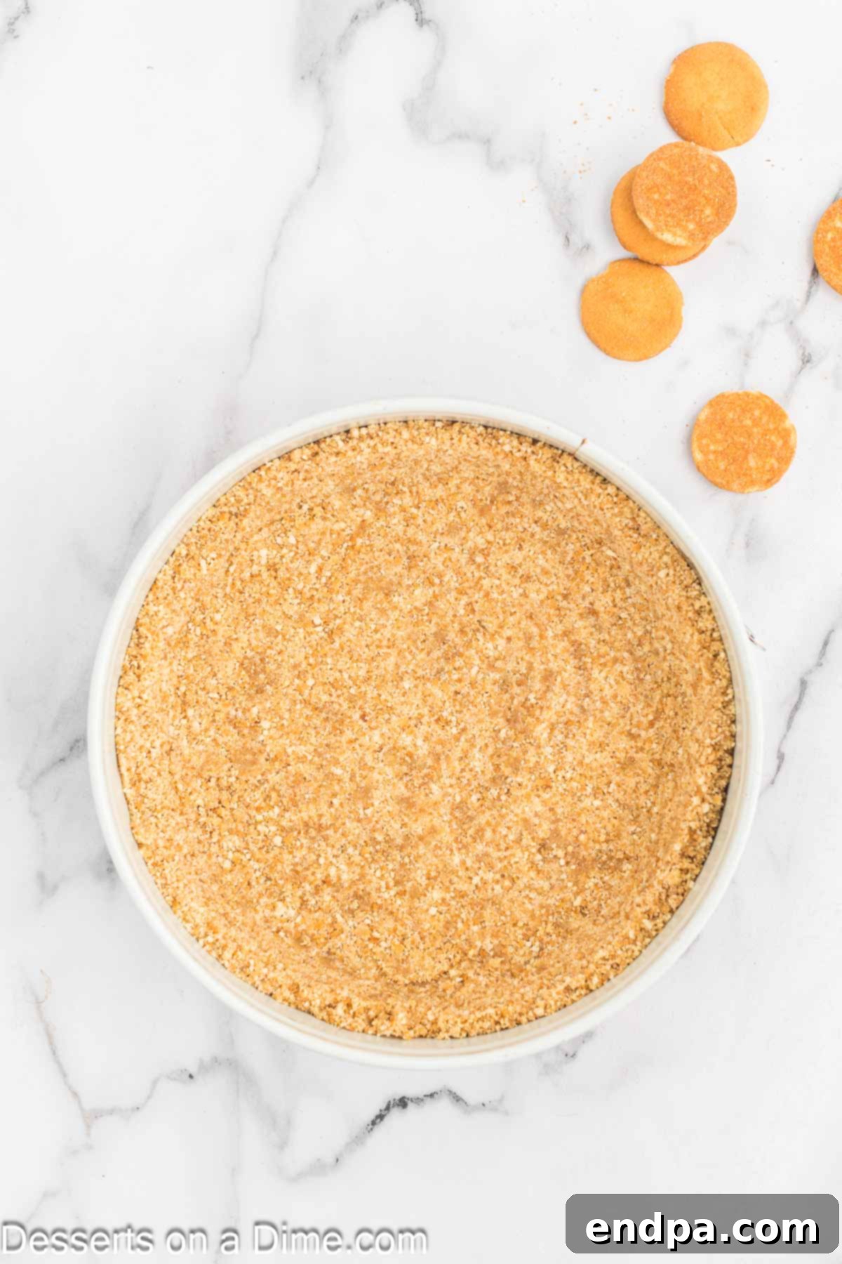 Golden Honey Swirl Cheesecake 4 Crushed nilla wafers pressed into a pan.