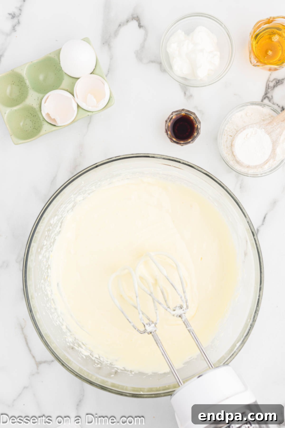 Golden Honey Swirl Cheesecake 6 Eggs added to mixture one at a time. Then sour cream, honey, vanilla and flour mixed in.