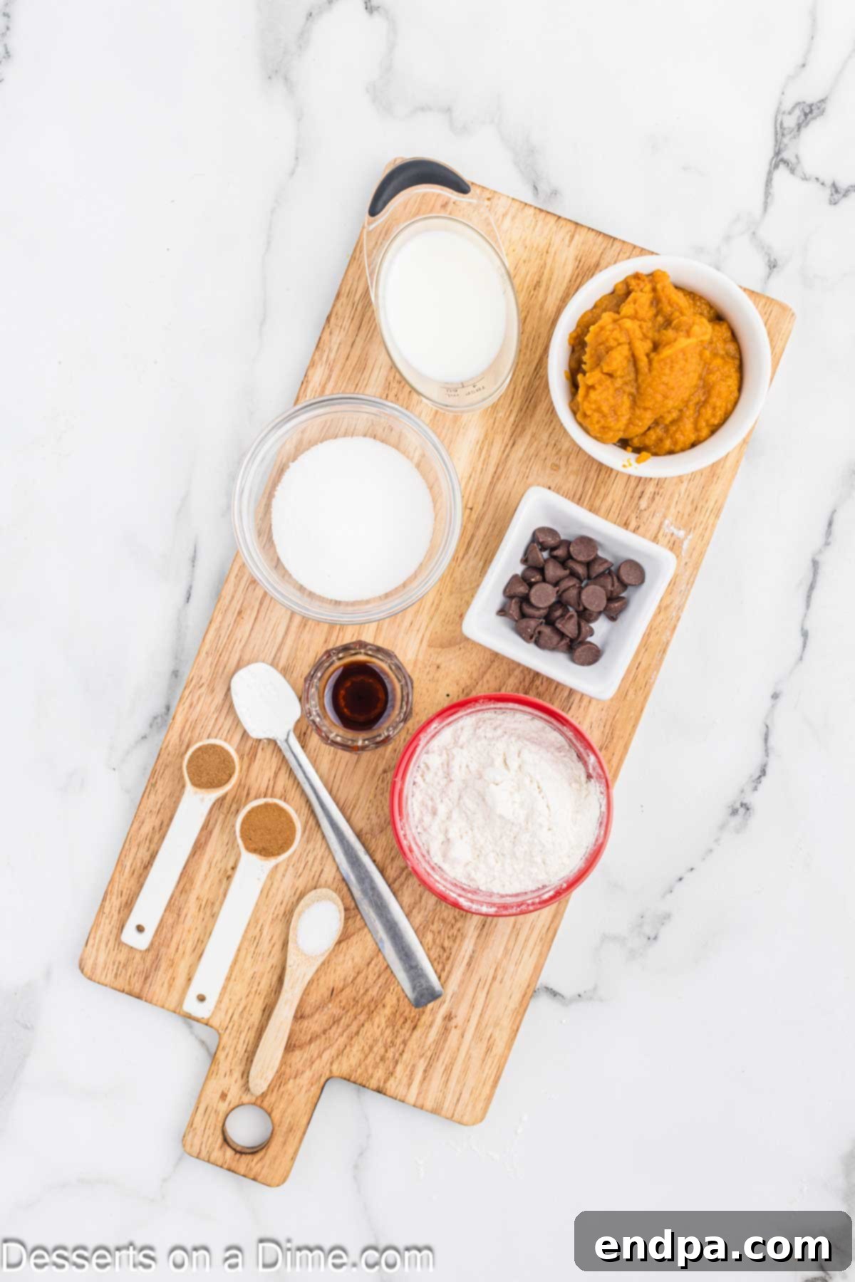 Ingredients for Pumpkin Mug Cake - flour, cinnamon, milk, pumpkin puree, vanilla extract, chocolate chips and whipped cream.
