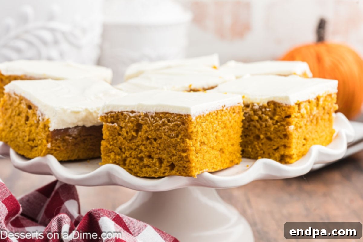 Delicious Paula Deen Pumpkin Bars, perfectly cut into squares and elegantly arranged on a pristine white platter, ready to be served and enjoyed.