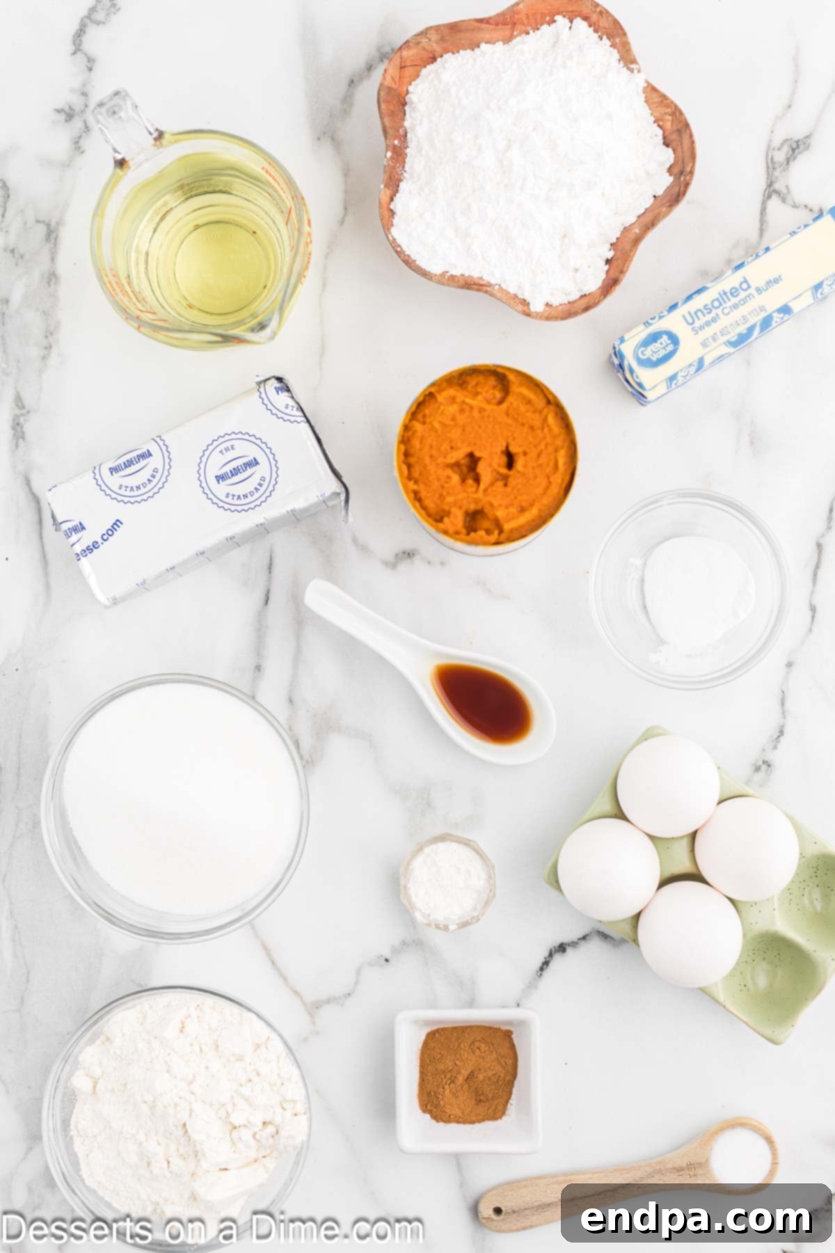 A beautiful flat lay photograph showcasing all the essential ingredients for Paula Deen Pumpkin Bars, including flour, cinnamon, baking soda, sugar, vegetable oil, pumpkin puree, large eggs, cream cheese, butter, powdered sugar, and vanilla extract.