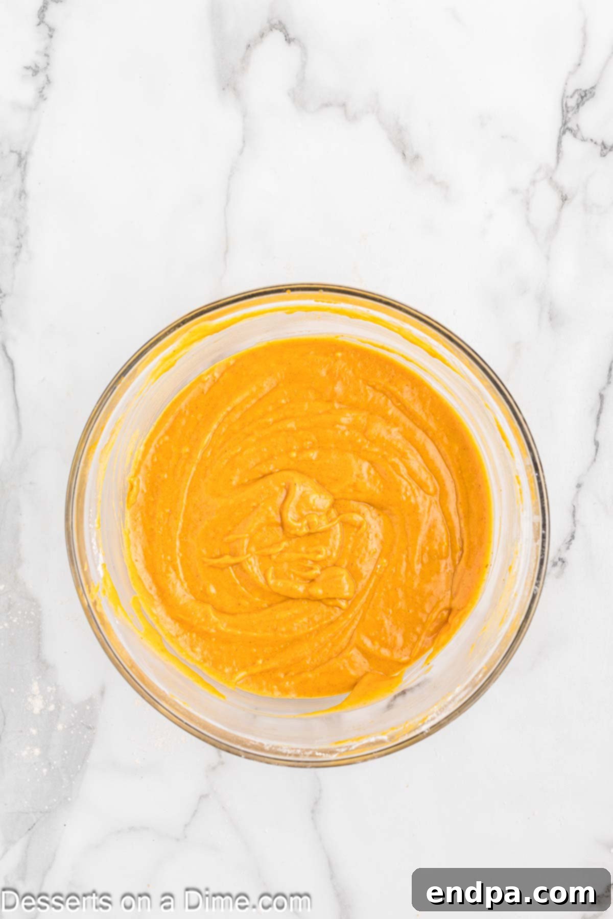 The combined wet and dry ingredients for pumpkin bars, gently mixed in a bowl until just incorporated.