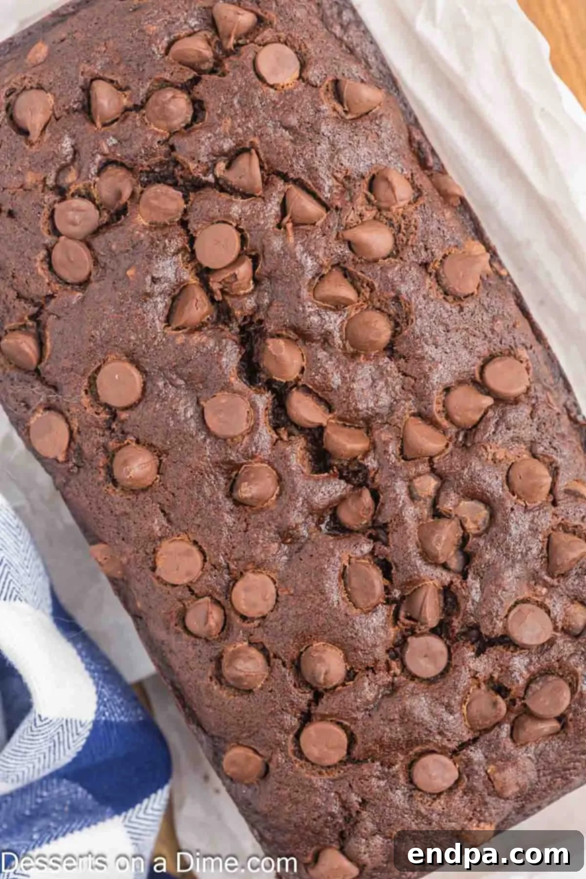Ultimate Chocolate Banana Loaf 11 A fully cooled loaf of Chocolate Banana Bread sitting on a cutting board, ready to be sliced.