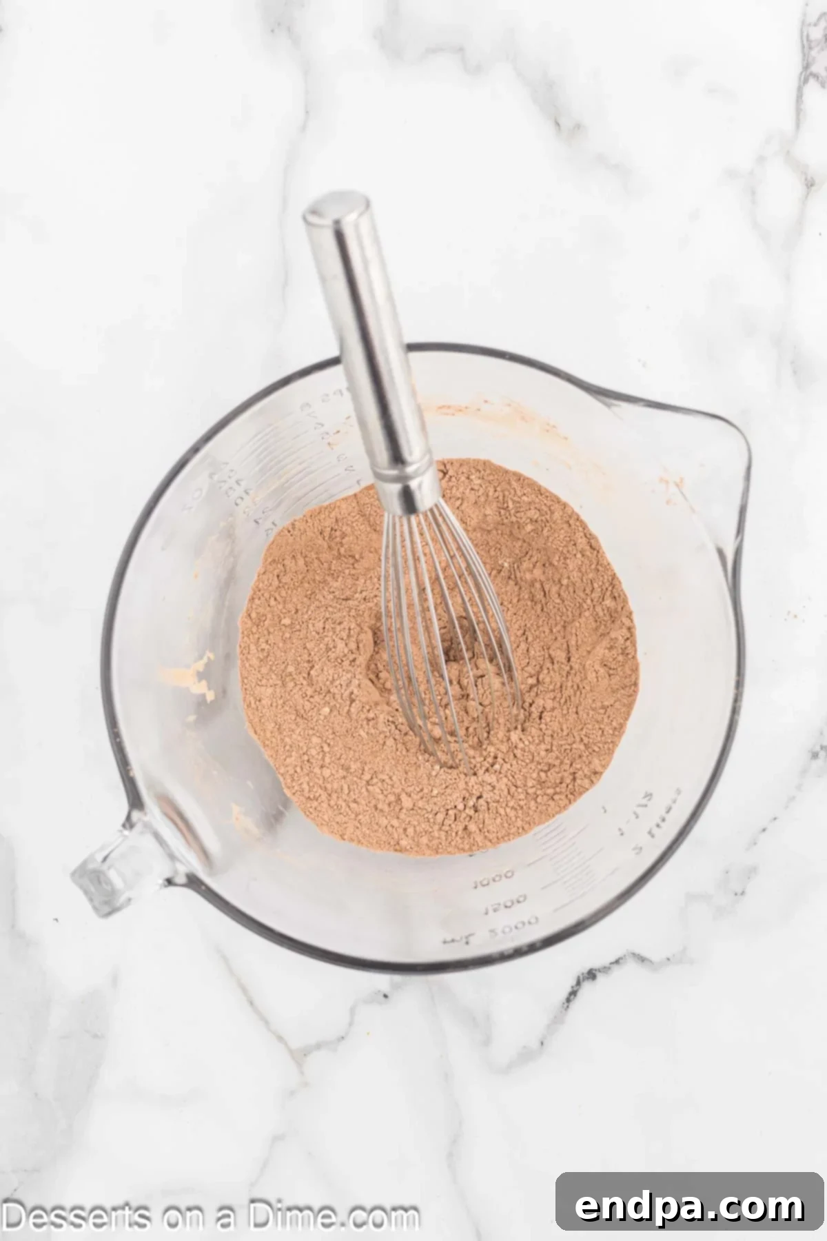 Ultimate Chocolate Banana Loaf 6 A mixing bowl containing dry ingredients: flour, cocoa powder, baking soda, and salt.