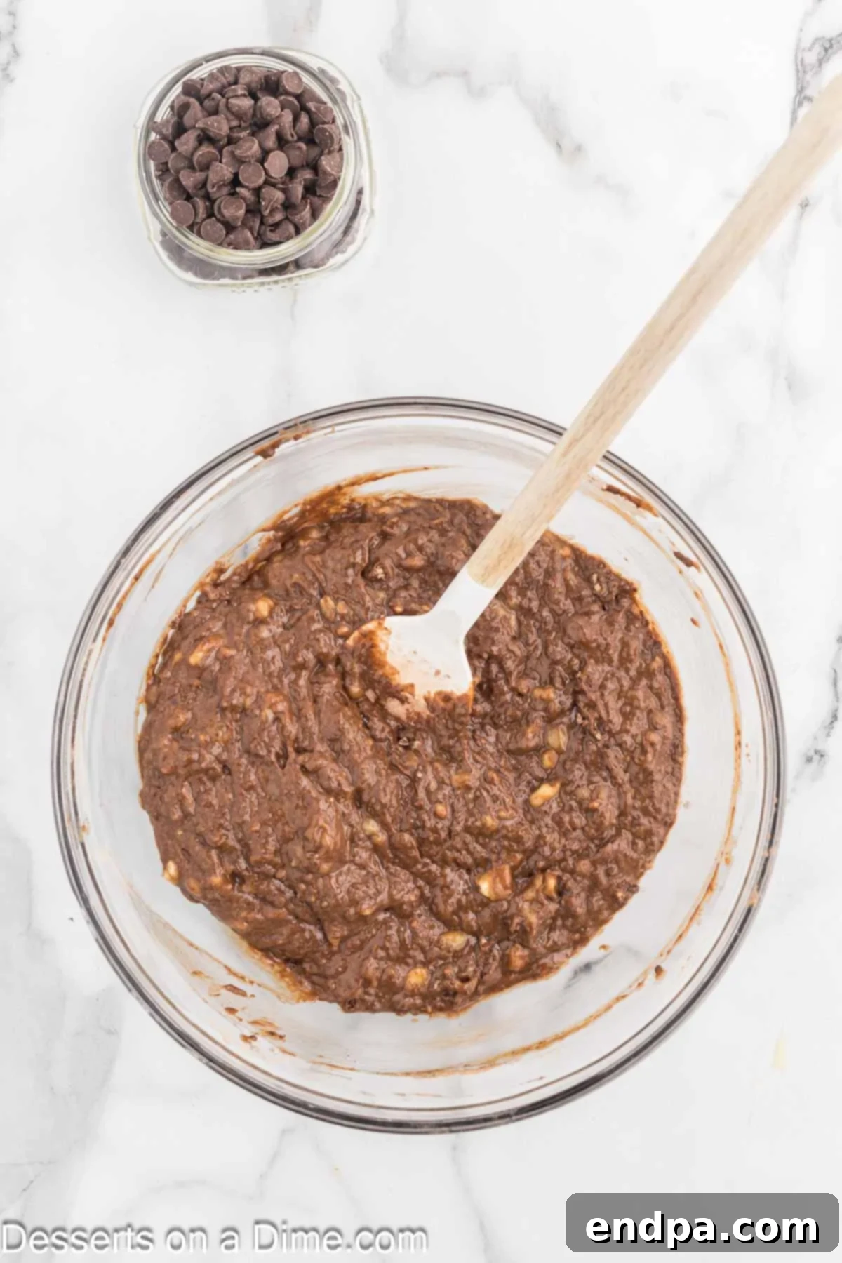 Ultimate Chocolate Banana Loaf 7 Wet ingredients being carefully folded into dry ingredients to form the banana bread batter.