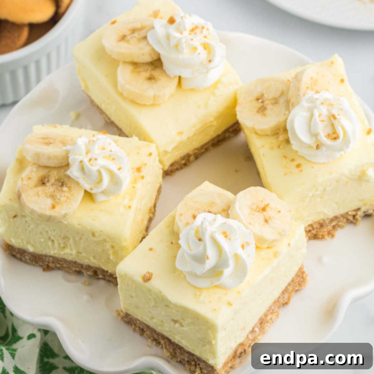 Dreamy Banana Cheesecake Bars 13 Beautifully garnished Banana Cream Cheesecake Bars ready to be served.