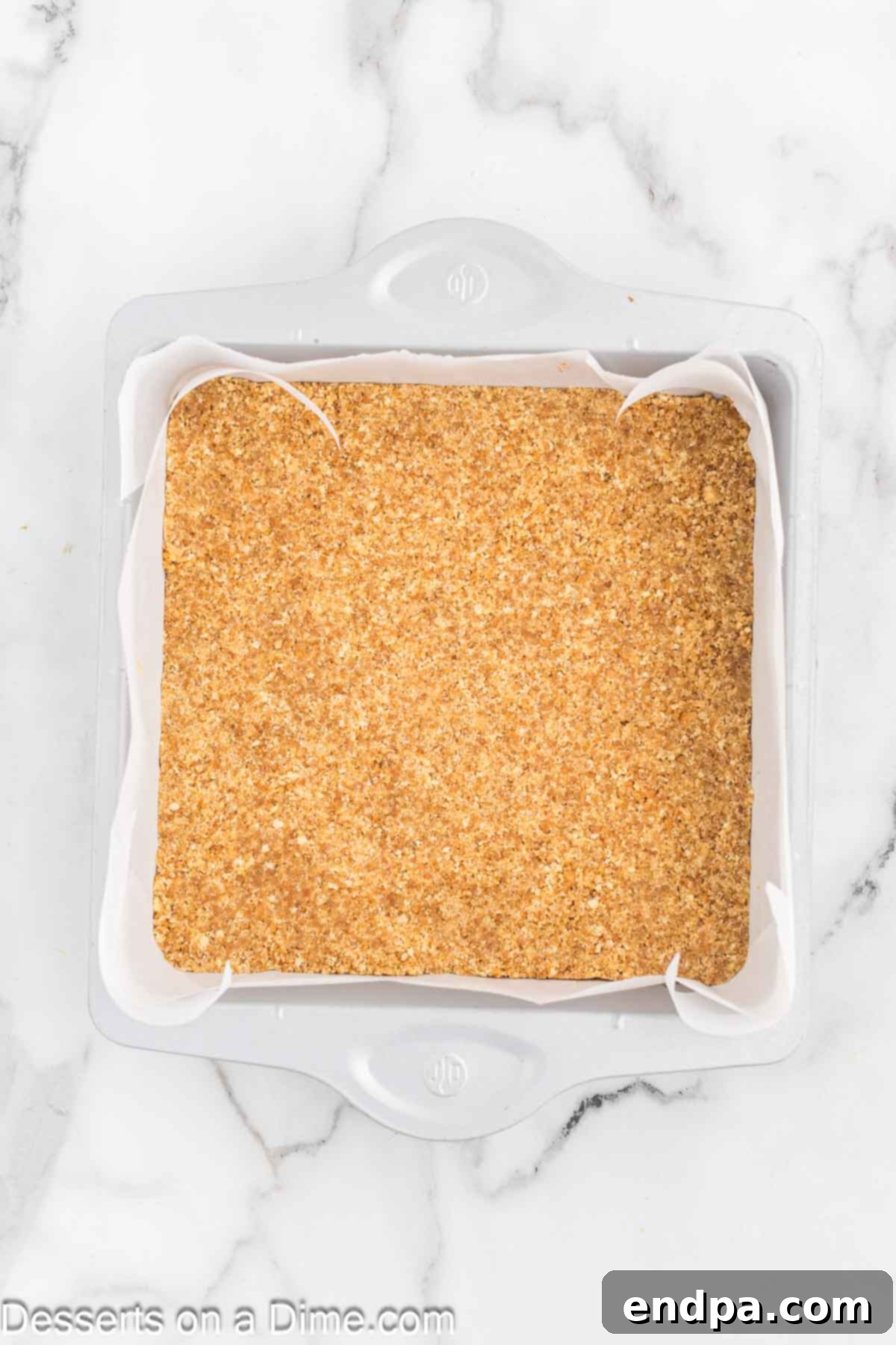Dreamy Banana Cheesecake Bars 5 The cookie crust mixture pressed evenly into a baking dish lined with parchment paper.