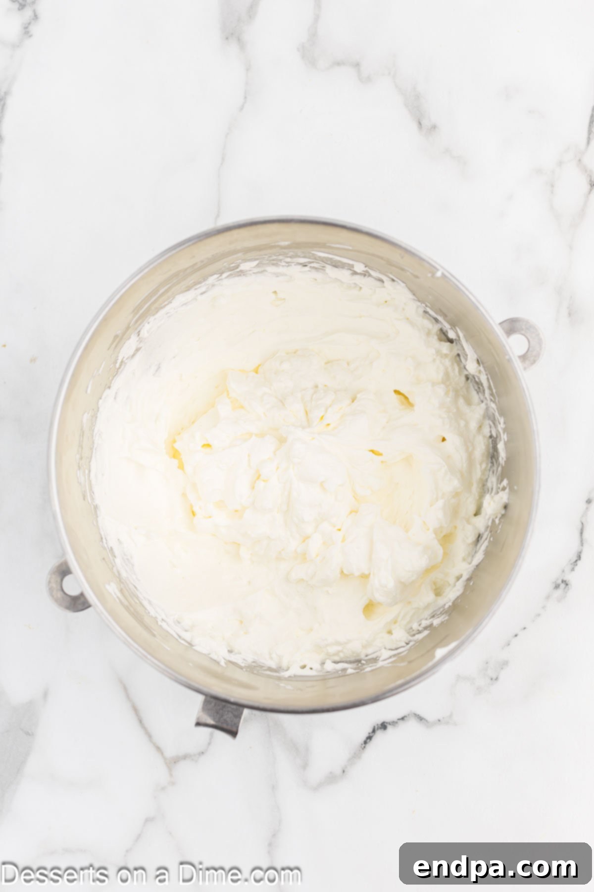 Dreamy Banana Cheesecake Bars 6 Heavy whipping cream in a cold mixing bowl, ready to be whipped.