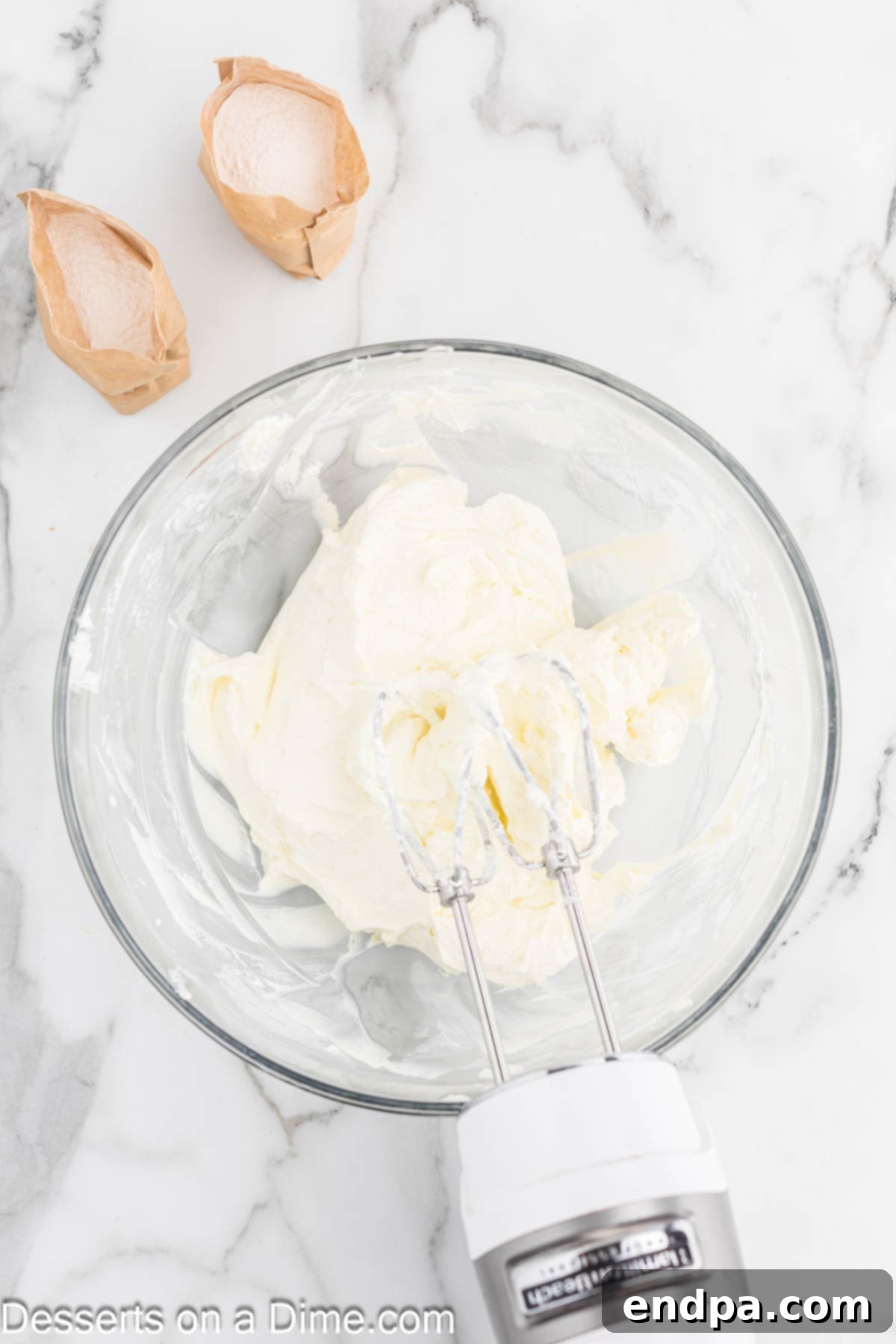 Dreamy Banana Cheesecake Bars 7 Cream cheese being beaten until light and fluffy in a separate bowl.