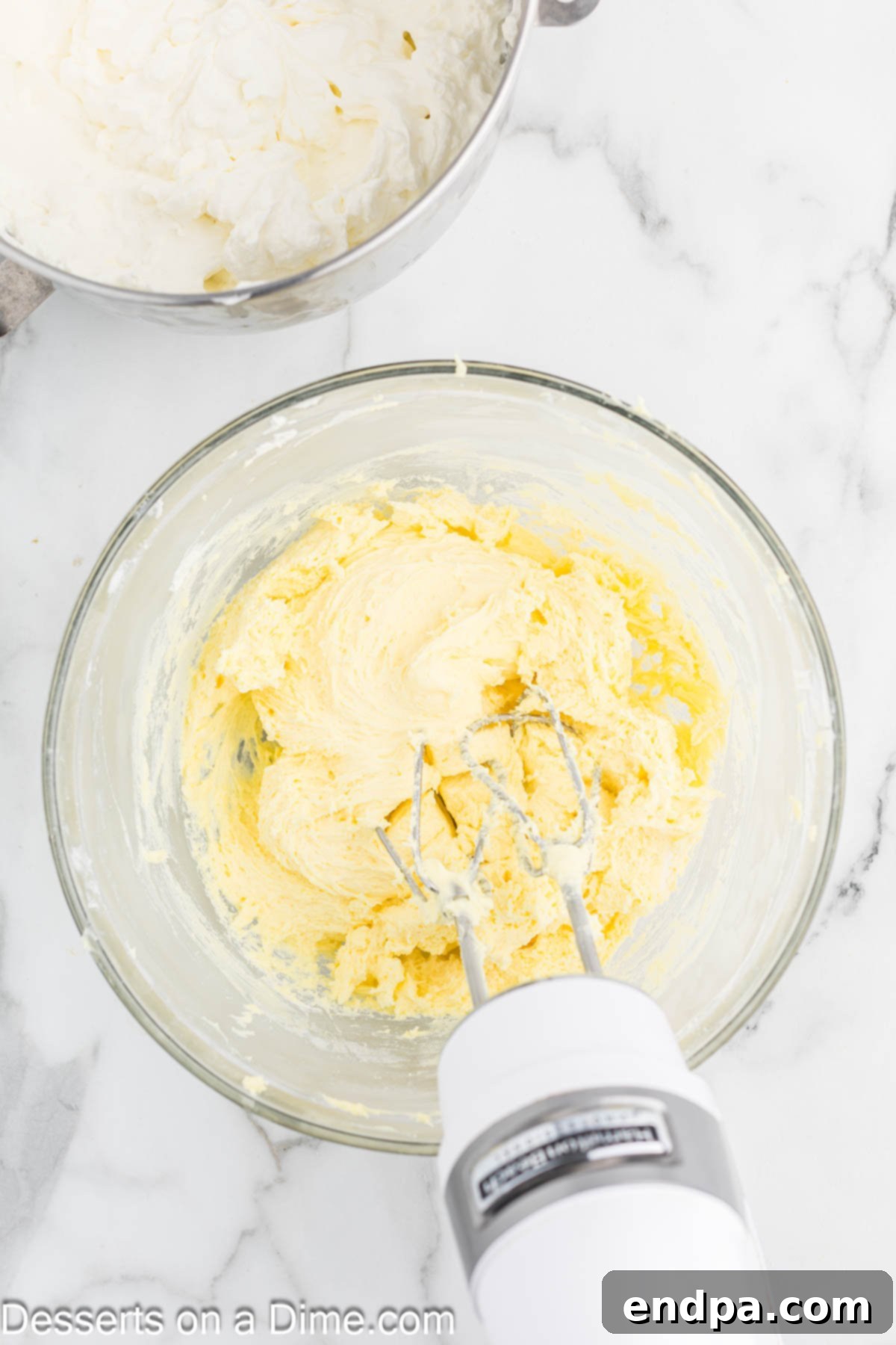 Dreamy Banana Cheesecake Bars 8 Instant banana pudding mix being added to the fluffy cream cheese and combined.