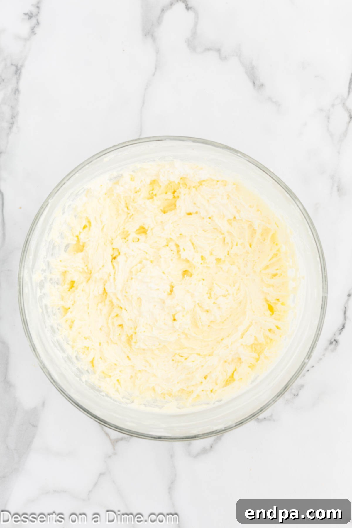 Dreamy Banana Cheesecake Bars 9 The pudding and whipped cream mixtures being gently folded together in a bowl.